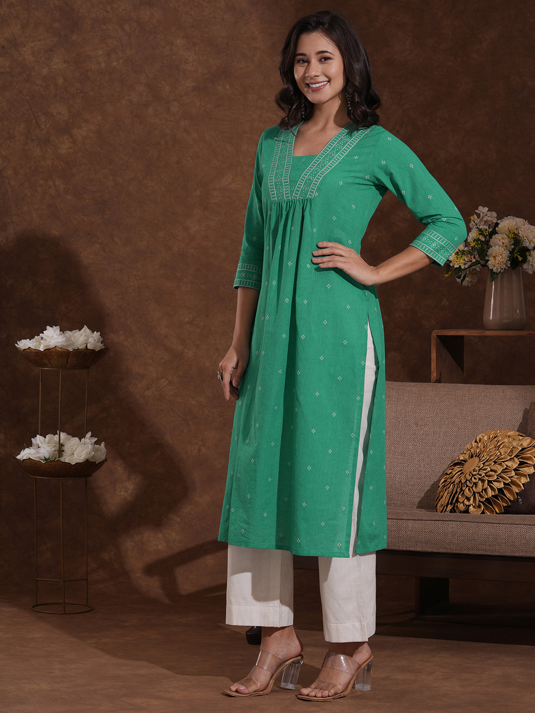 Straight kurta with border detailing on the neck and sleeves with mirrorwork.