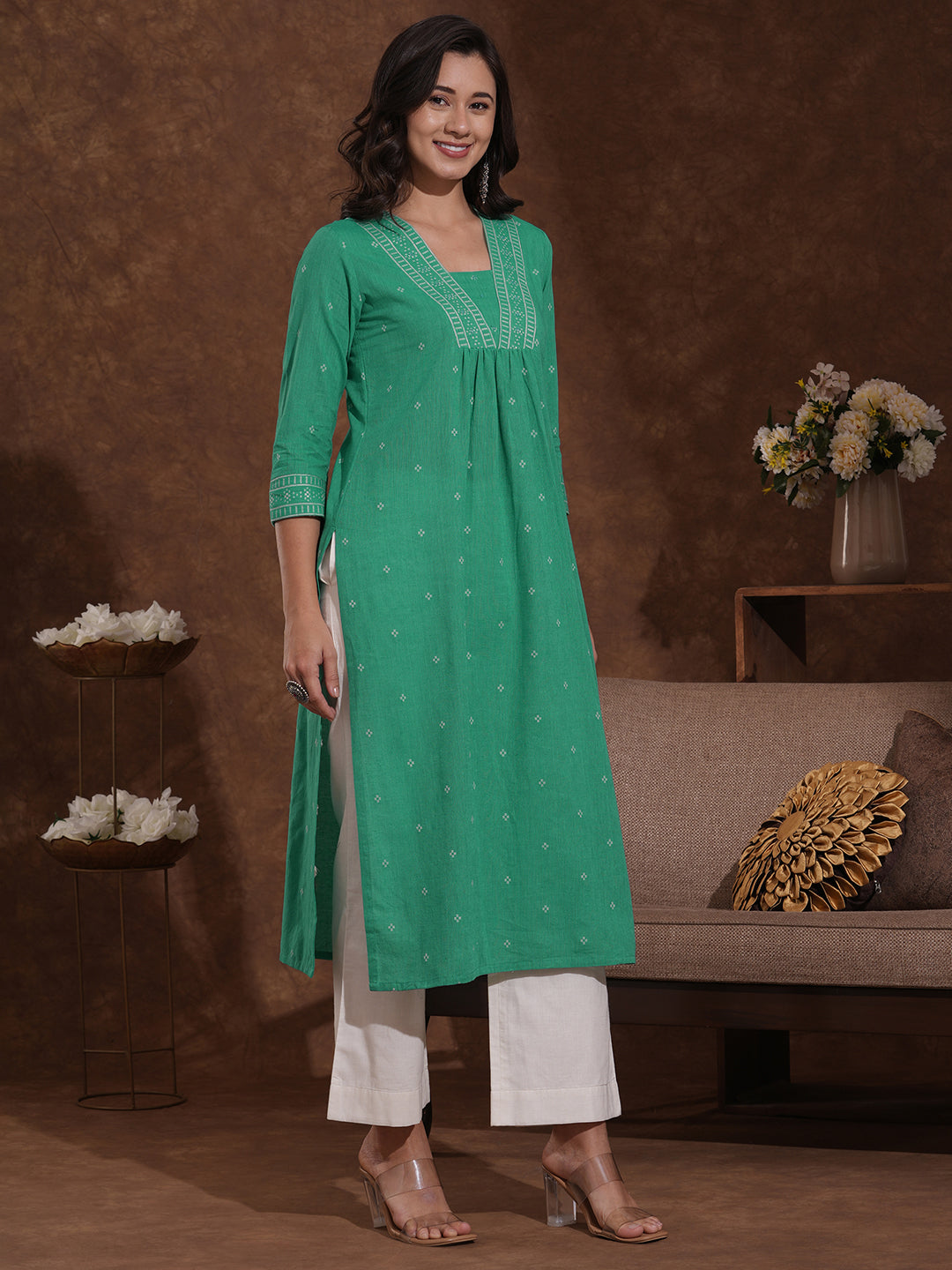 Straight kurta with border detailing on the neck and sleeves with mirrorwork.