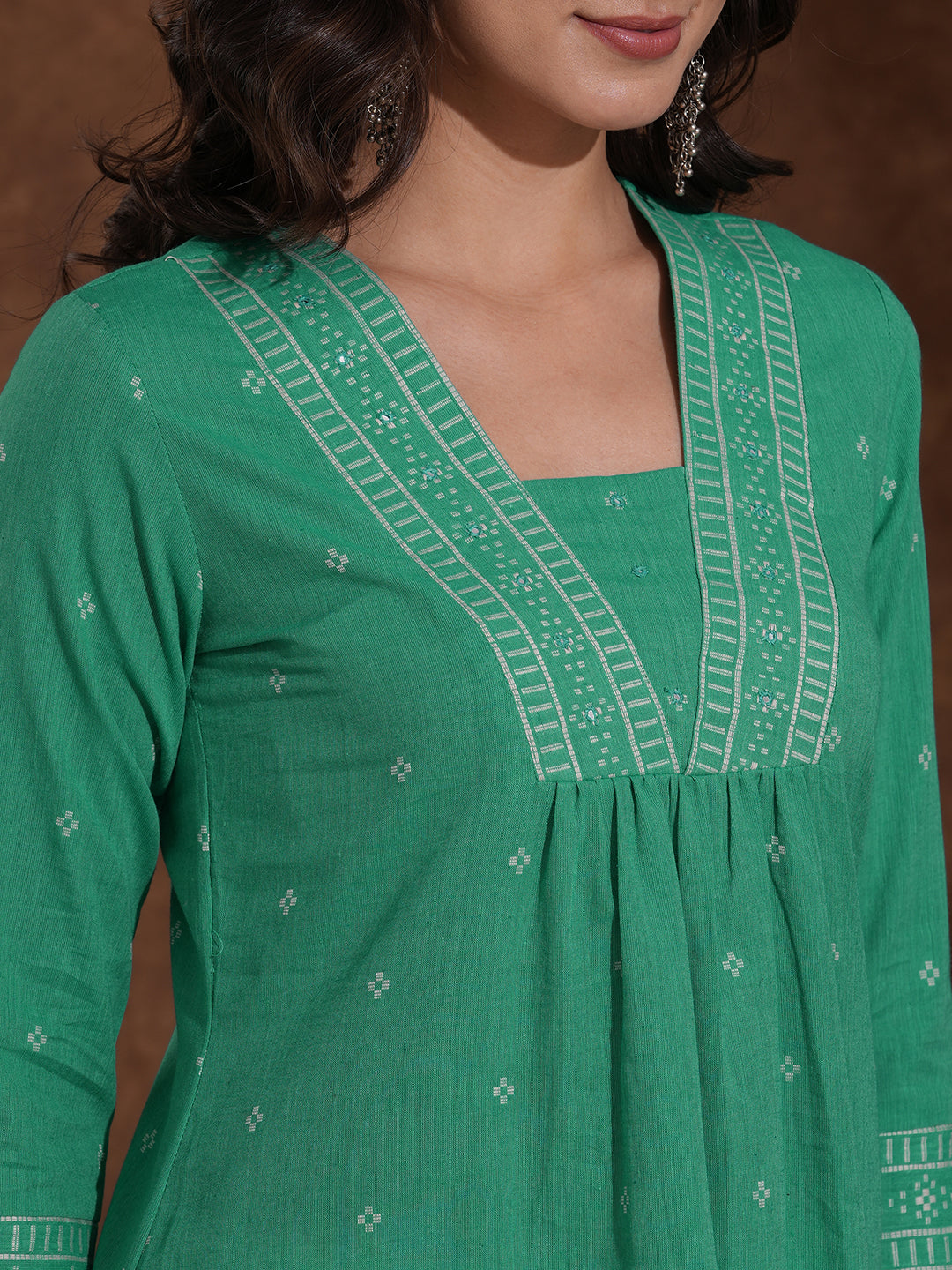Straight kurta with border detailing on the neck and sleeves with mirrorwork.