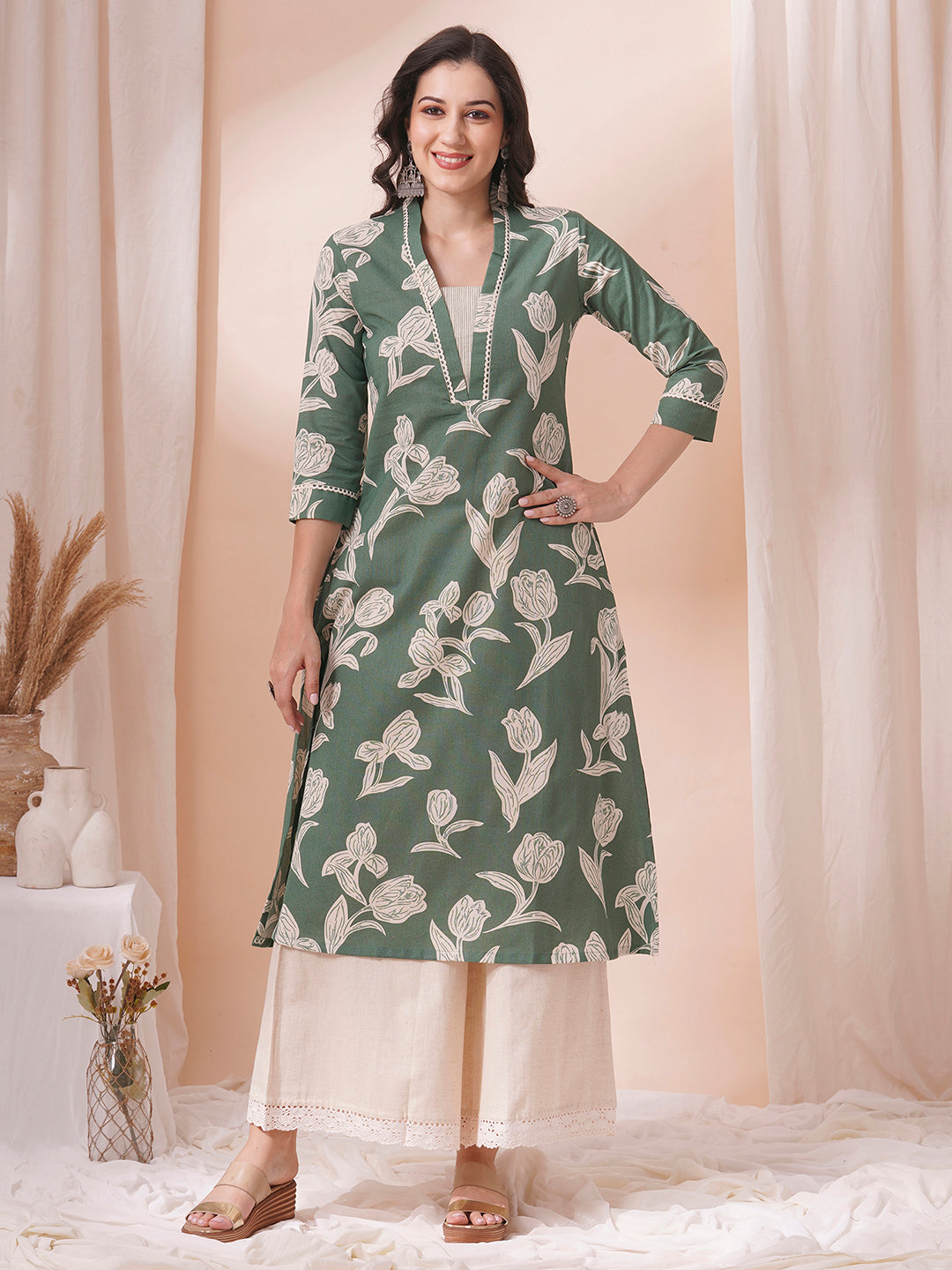 A flex printed A-line kurta with stitch line and lace detailing.