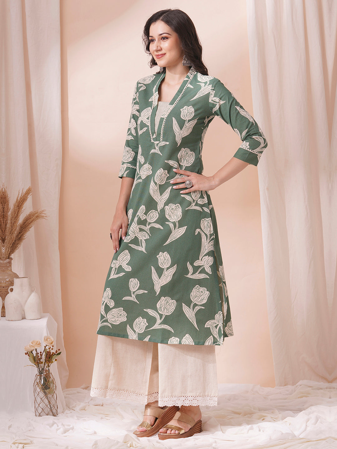 A flex printed A-line kurta with stitch line and lace detailing.