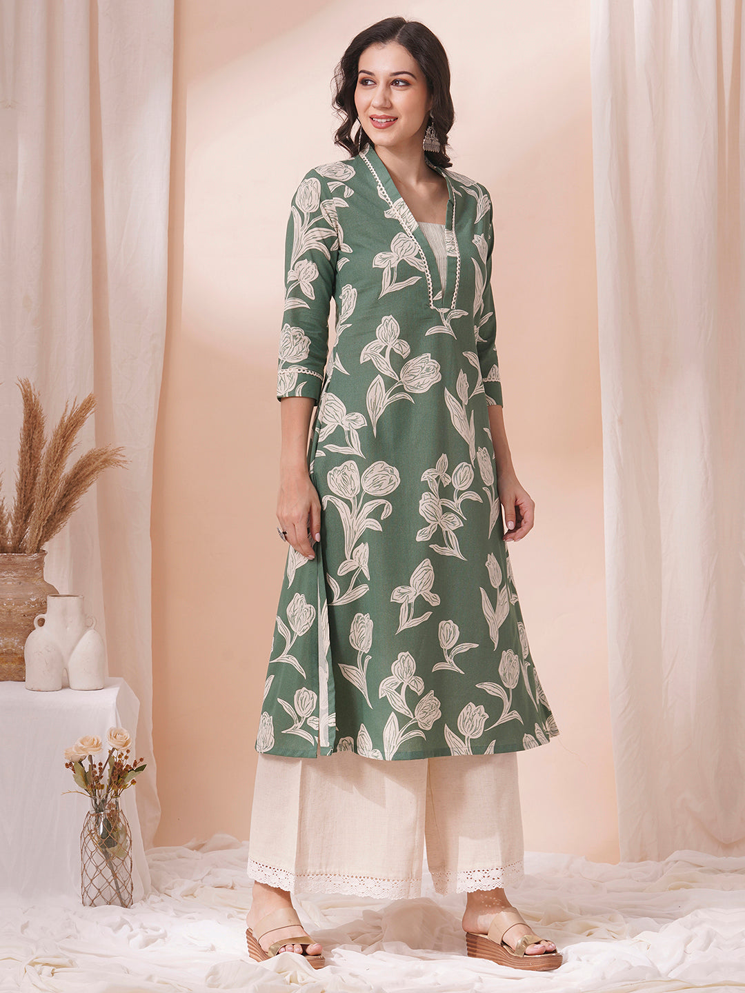 A flex printed A-line kurta with stitch line and lace detailing.
