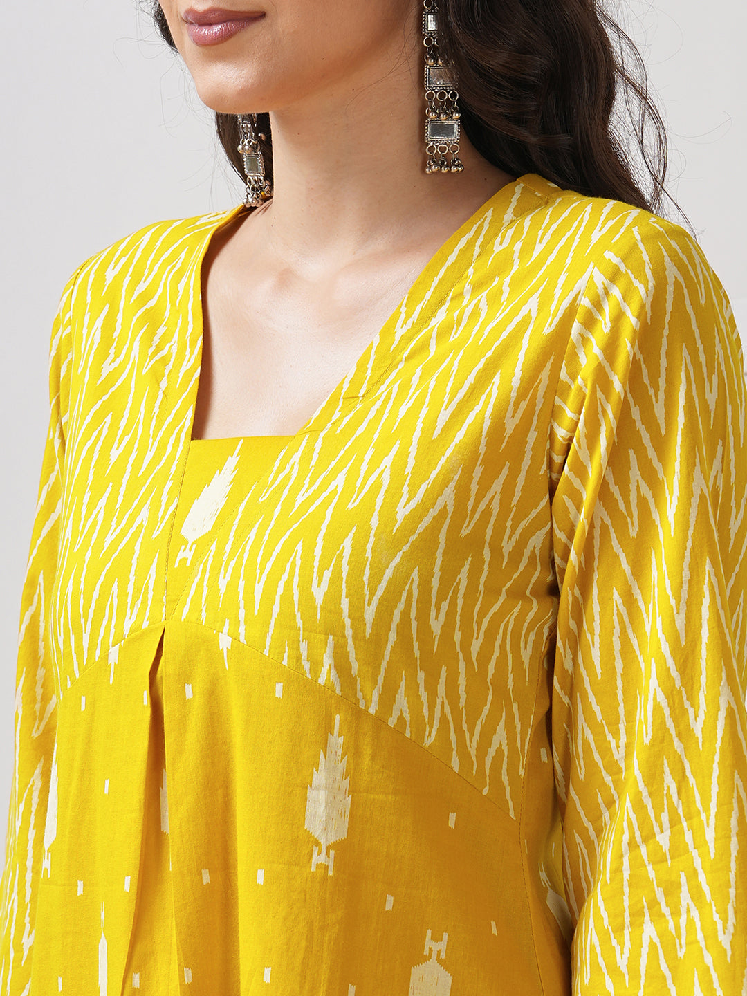 Straight fit shaped waist kurta with coordinated print yoke and bell sleeves.