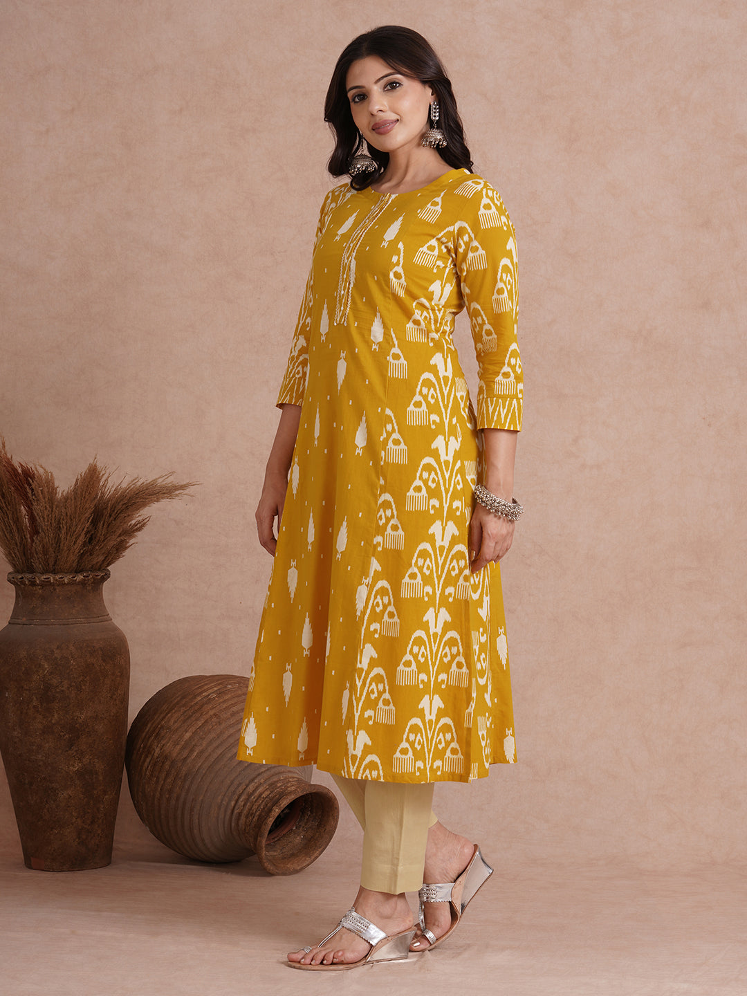A-Line shoulder princess kurta with coordinating prints and handwork around placket.