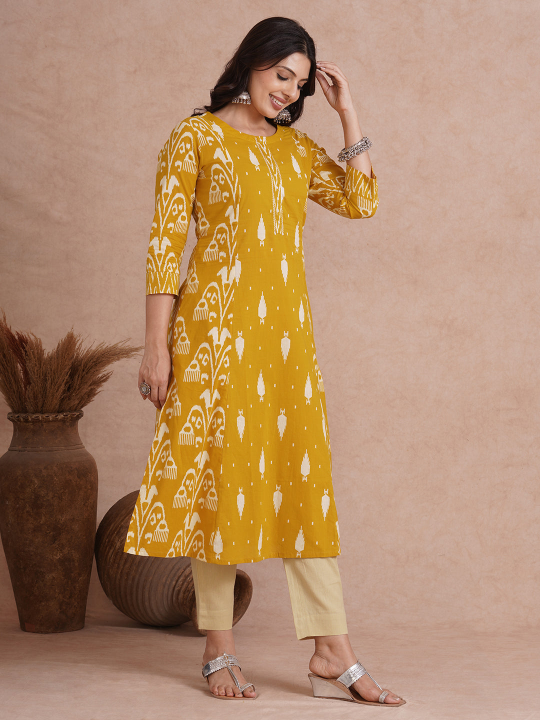A-Line shoulder princess kurta with coordinating prints and handwork around placket.