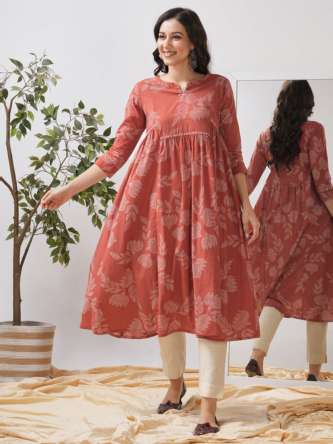 Printed flared kurta with layered waist gathers and trim detailing with handwork mirrors.
