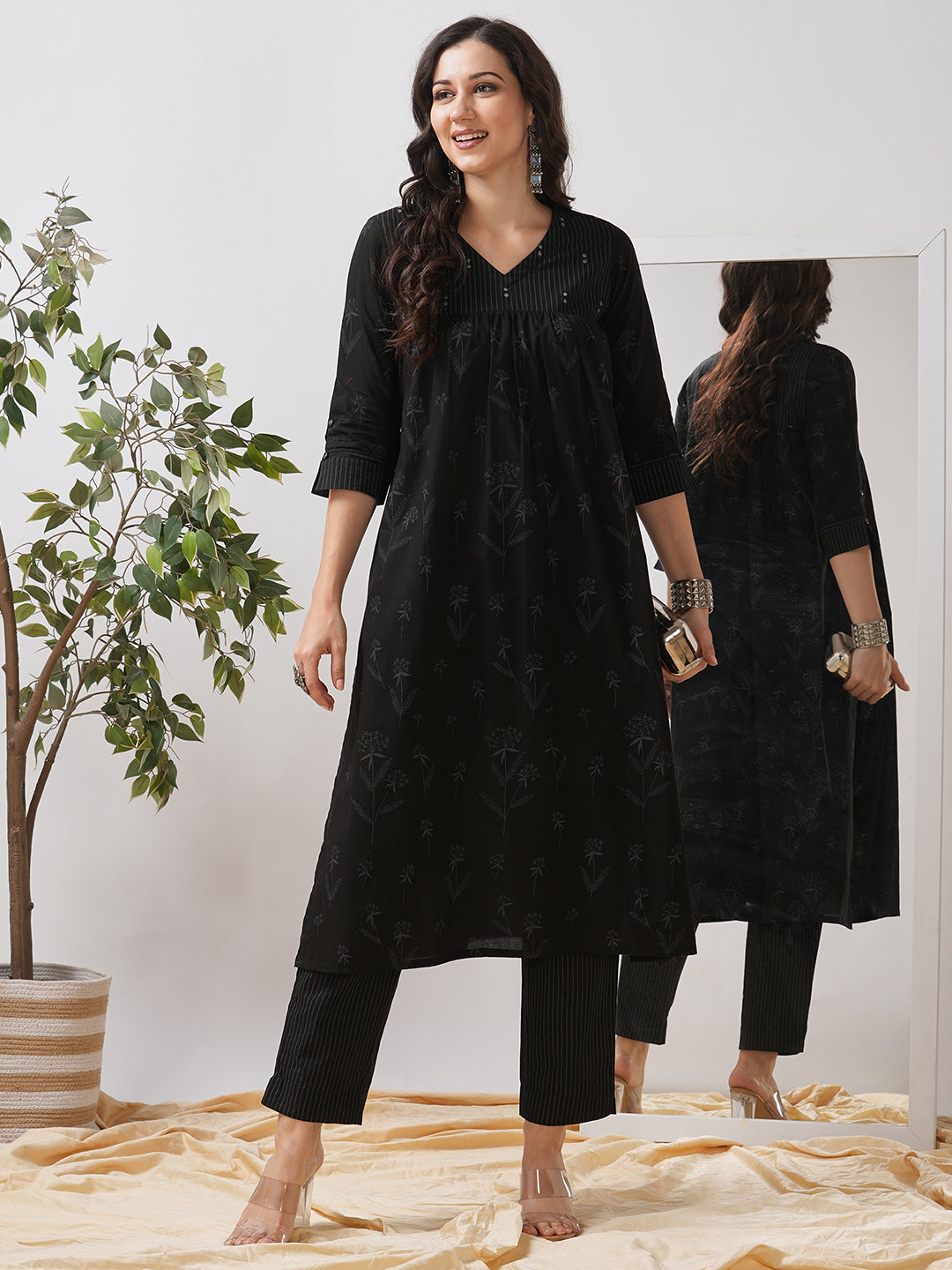 A gathered kurta with mirrorwork shoulder yoke and cuffed sleeves.