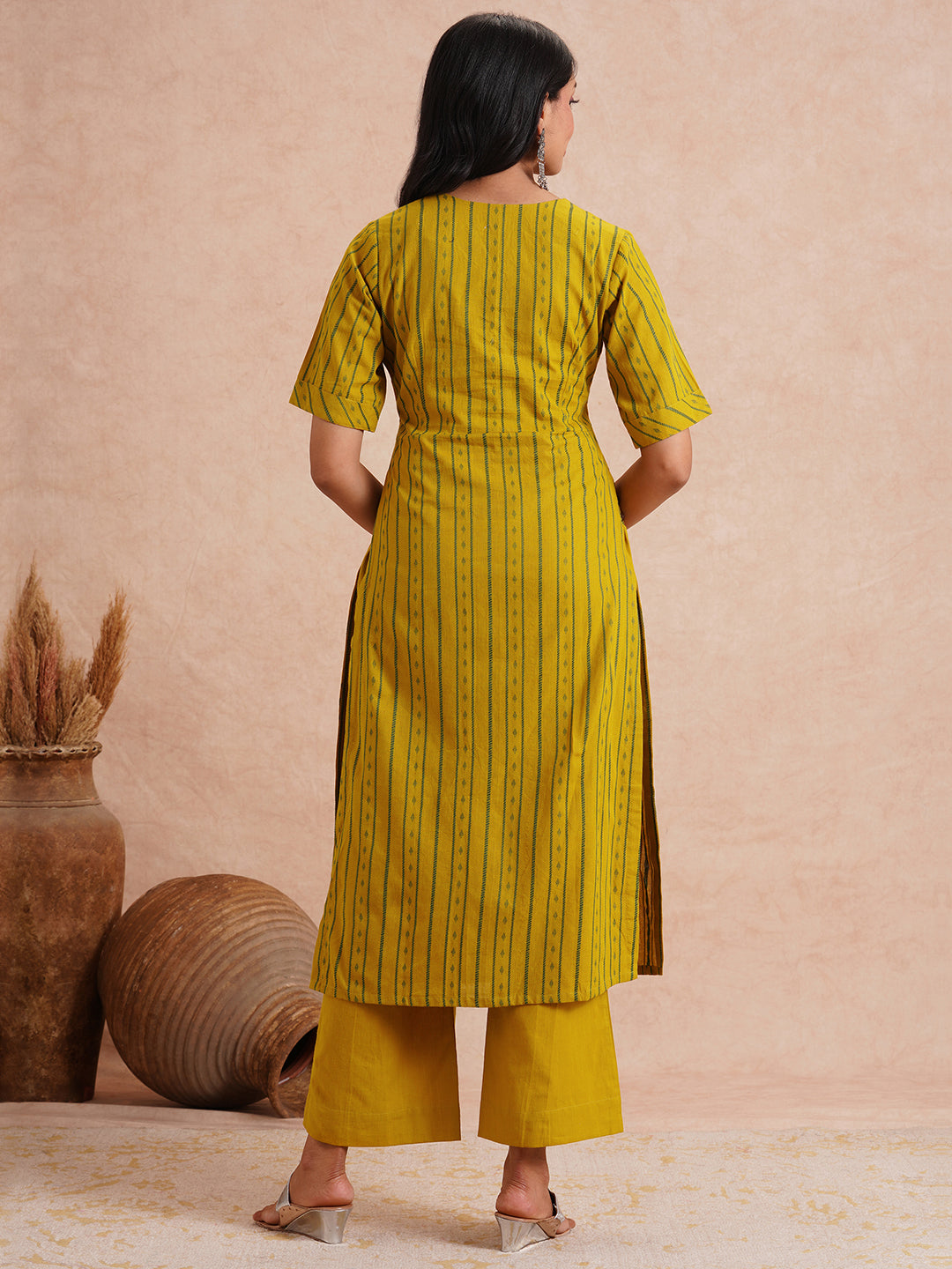 Straight fit kurta set with half sleeves and button detailing paired with plain palazzo.