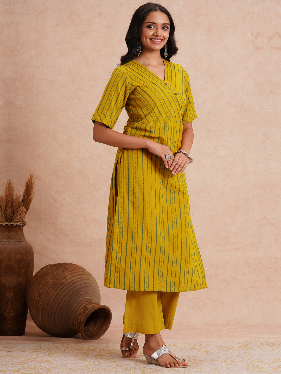 Straight fit kurta set with half sleeves and button detailing paired with plain palazzo.