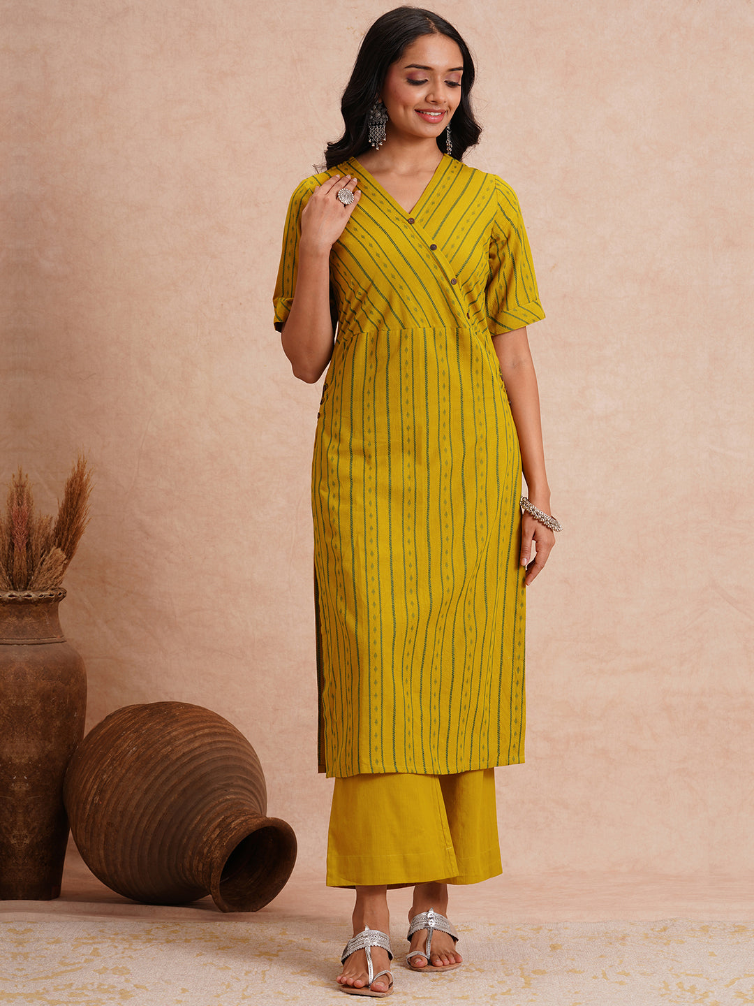 Straight fit kurta set with half sleeves and button detailing paired with plain palazzo.