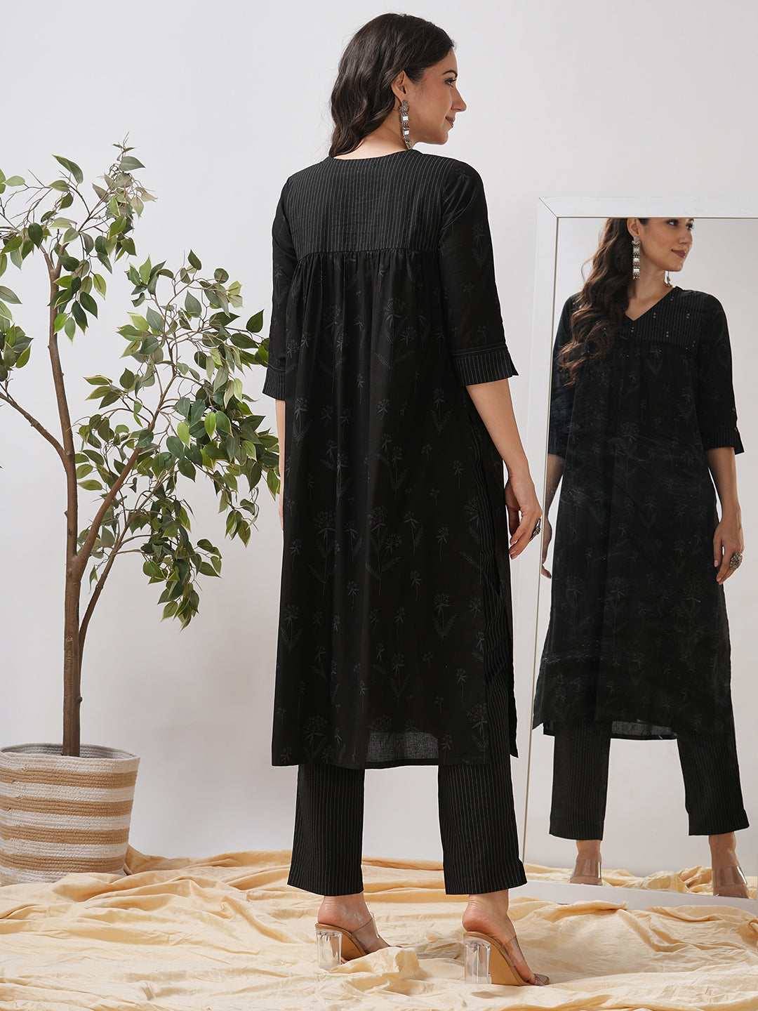 A gathered kurta set with mirrorwork shoulder yoke and cuffed sleeves paired with pant.