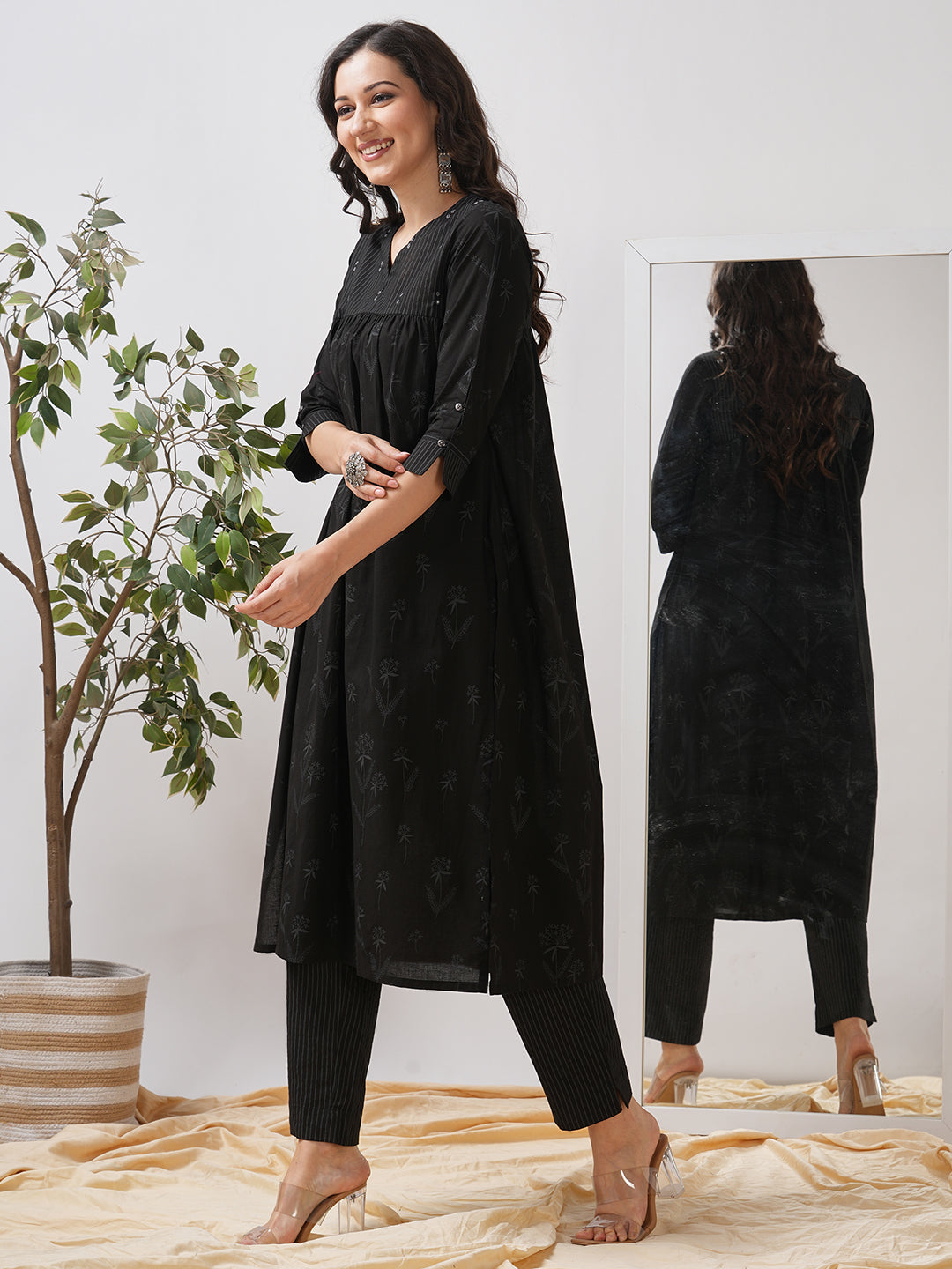 A gathered kurta set with mirrorwork shoulder yoke and cuffed sleeves paired with pant.