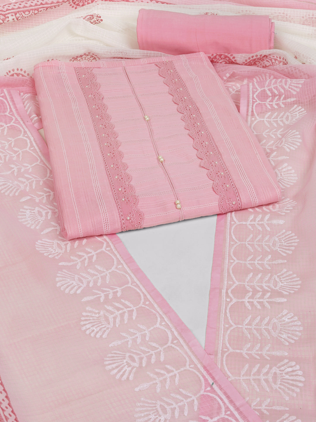 A light pink unstitched suit set with intricate top paired with plain bottom and Kota doria dupatta.
