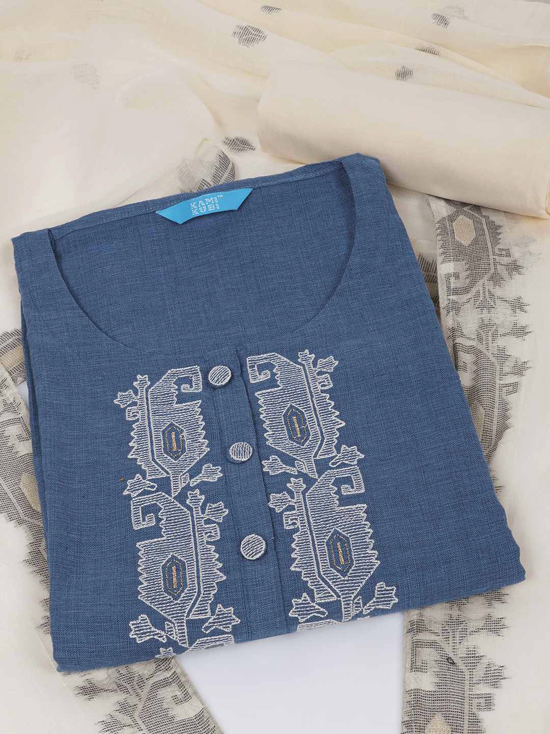 3-piece unstitched set features a blue embroidered top paired with a soft cream dupatta showcasing subtle woven motifs.
