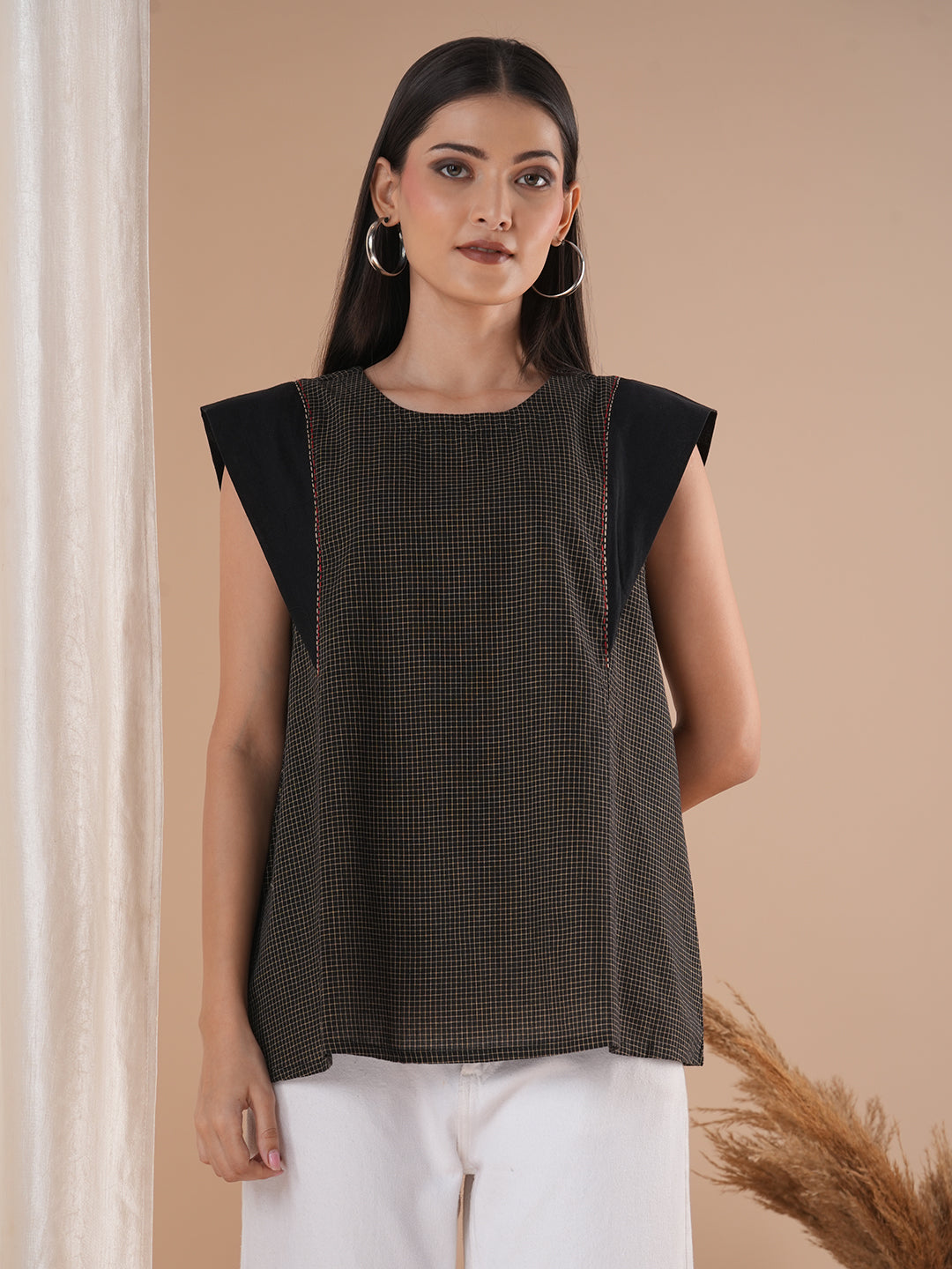 Black flared top in chequered cotton fabric with hand embroidered running stitch