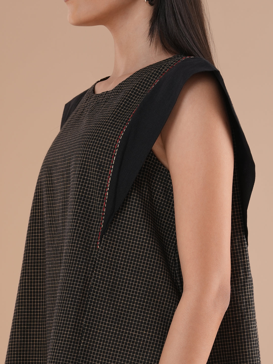 Black flared top in chequered cotton fabric with hand embroidered running stitch