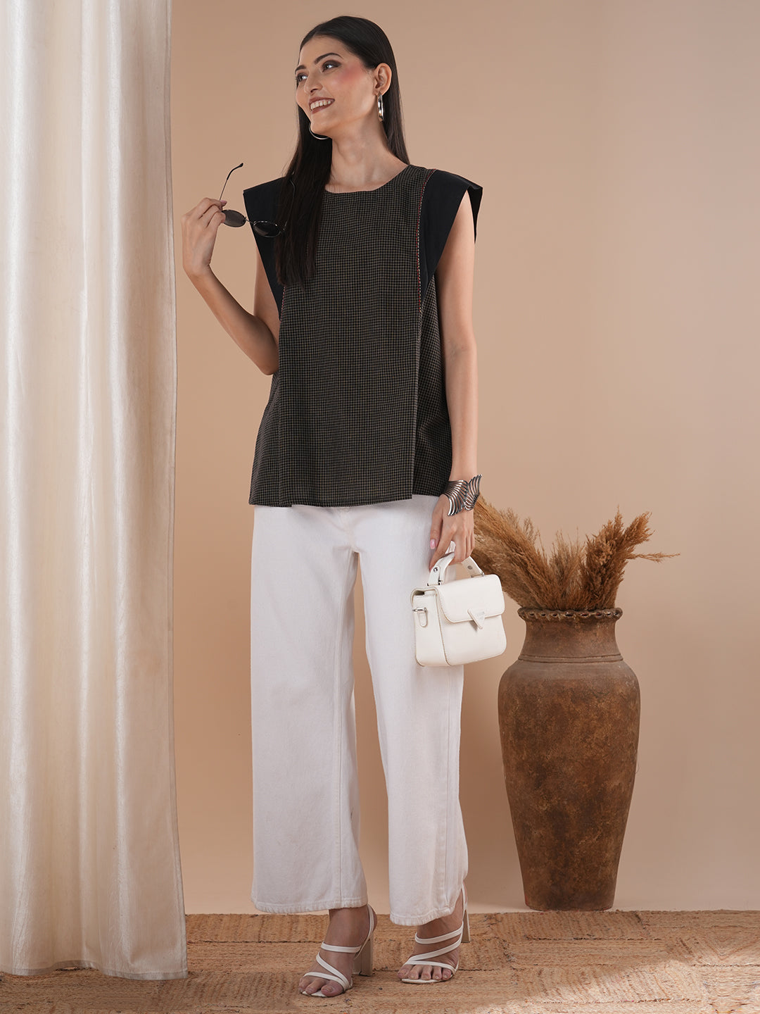 Black flared top in chequered cotton fabric with hand embroidered running stitch