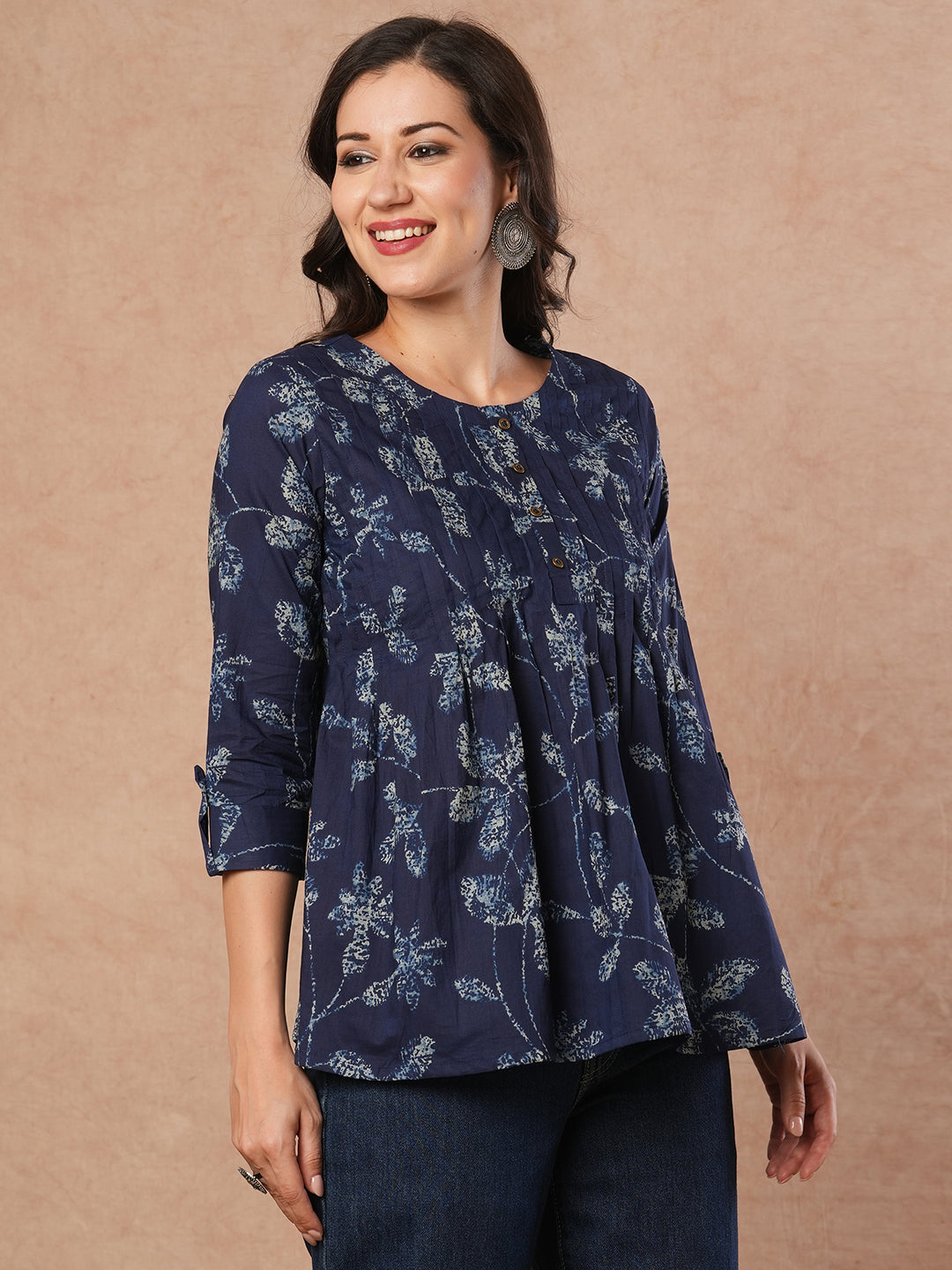 Pleated cotton print top with loop and button detailing on sleeve.