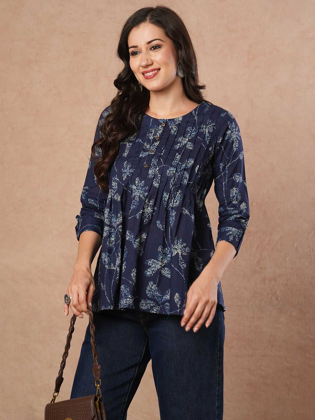 Pleated cotton print top with loop and button detailing on sleeve.