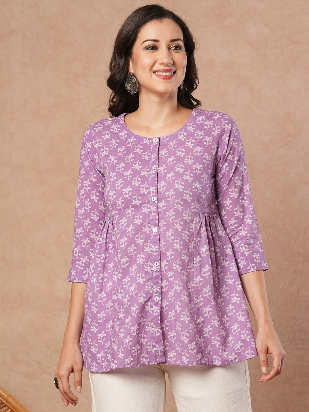 Printed top with centre button placket and pleated side panels.