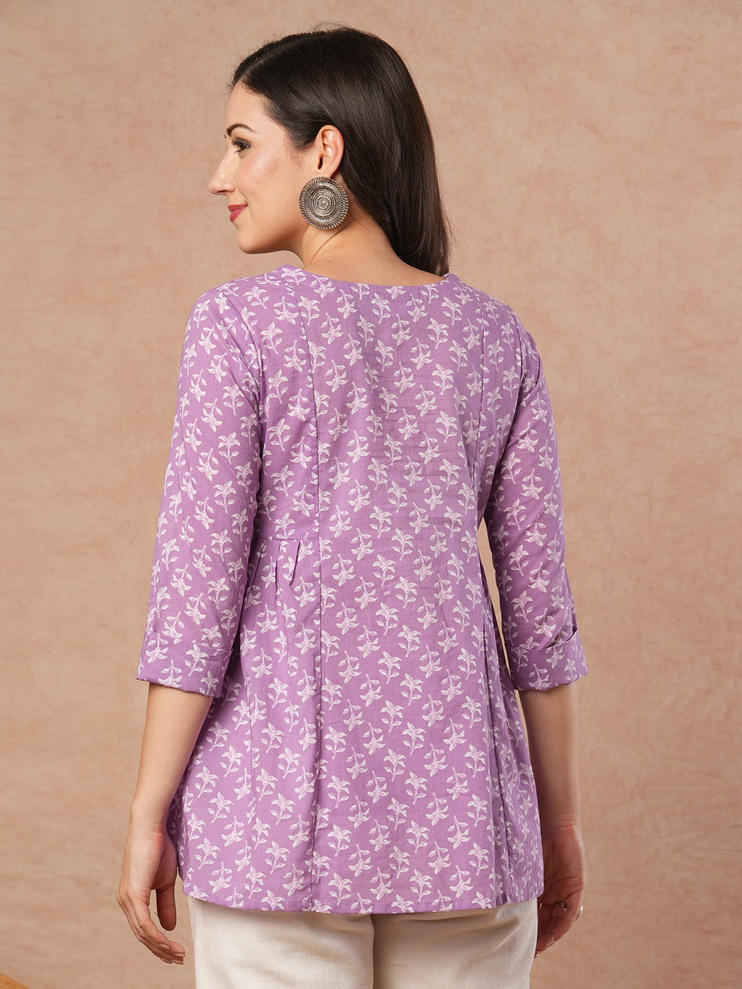 Printed top with centre button placket and pleated side panels.