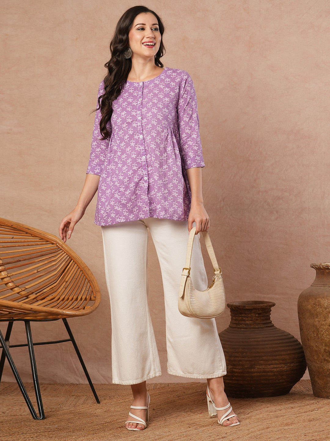 Printed top with centre button placket and pleated side panels.