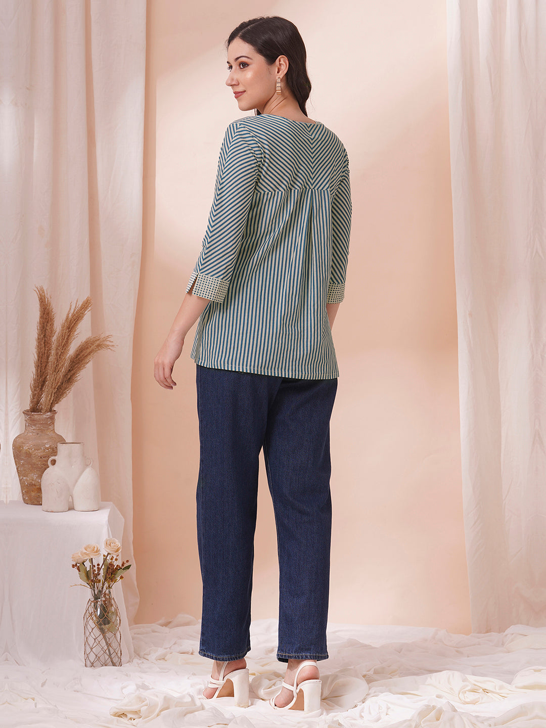 Striped top with mitered yoke and sleeves with polka border and cuff.