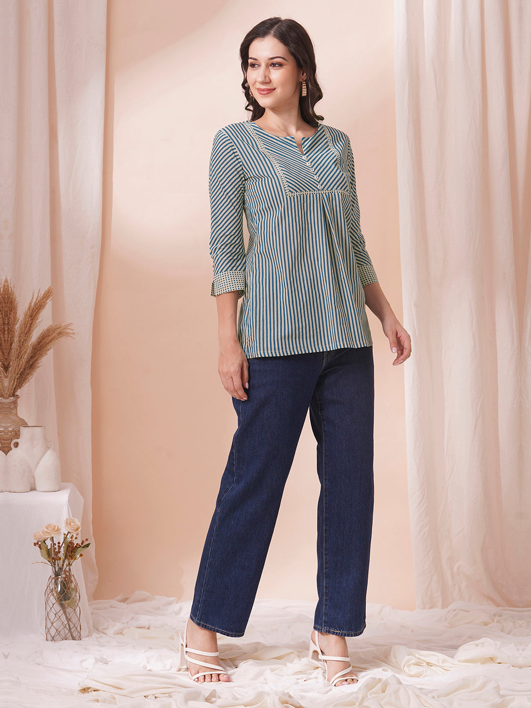 Striped top with mitered yoke and sleeves with polka border and cuff.