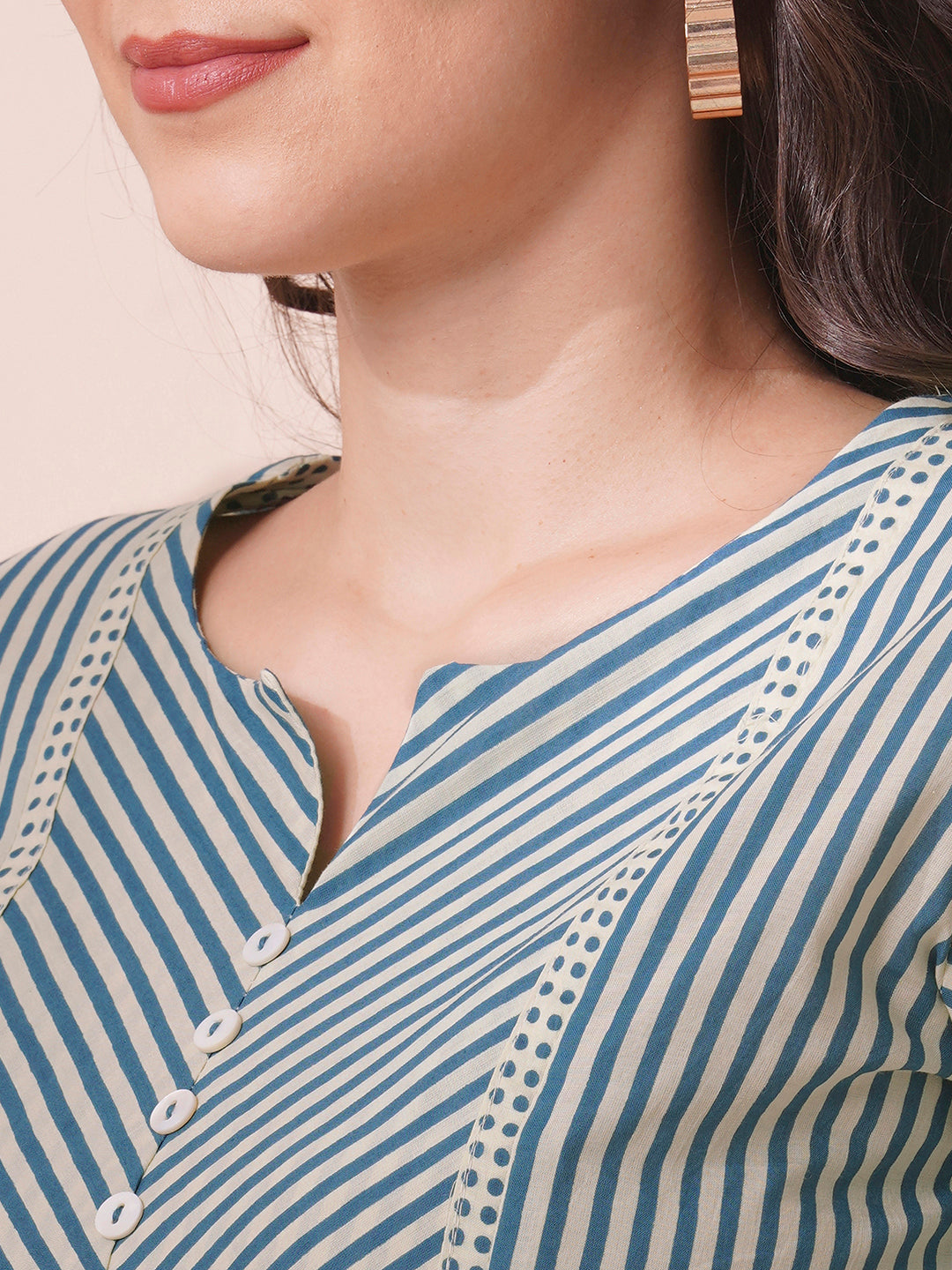 Striped top with mitered yoke and sleeves with polka border and cuff.