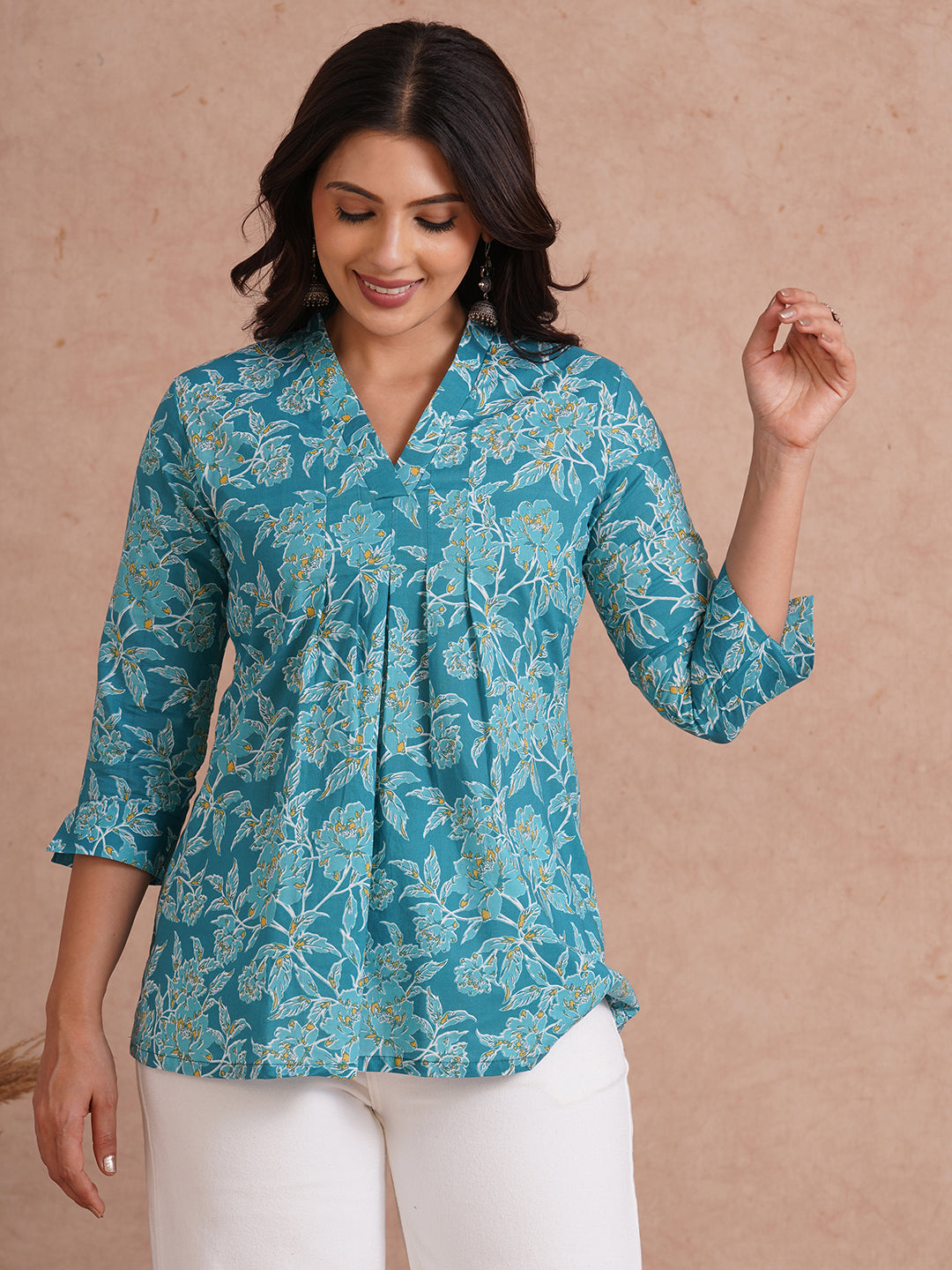 Printed top with knife pleat detailing and a V-neckline.