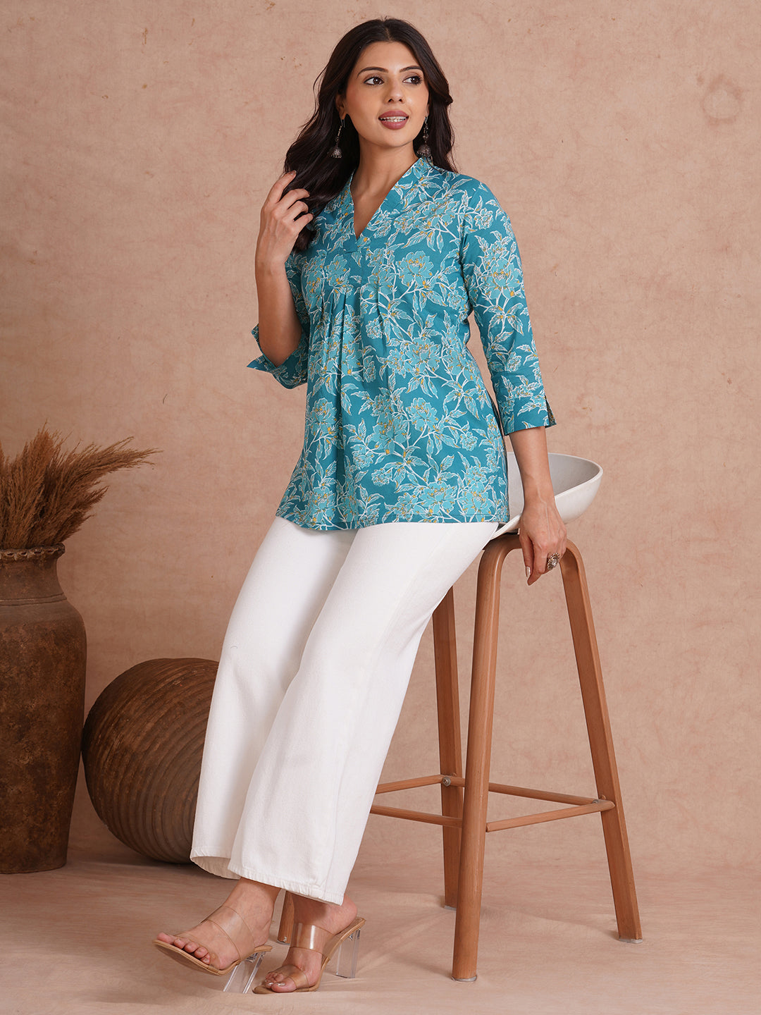 Printed top with knife pleat detailing and a V-neckline.