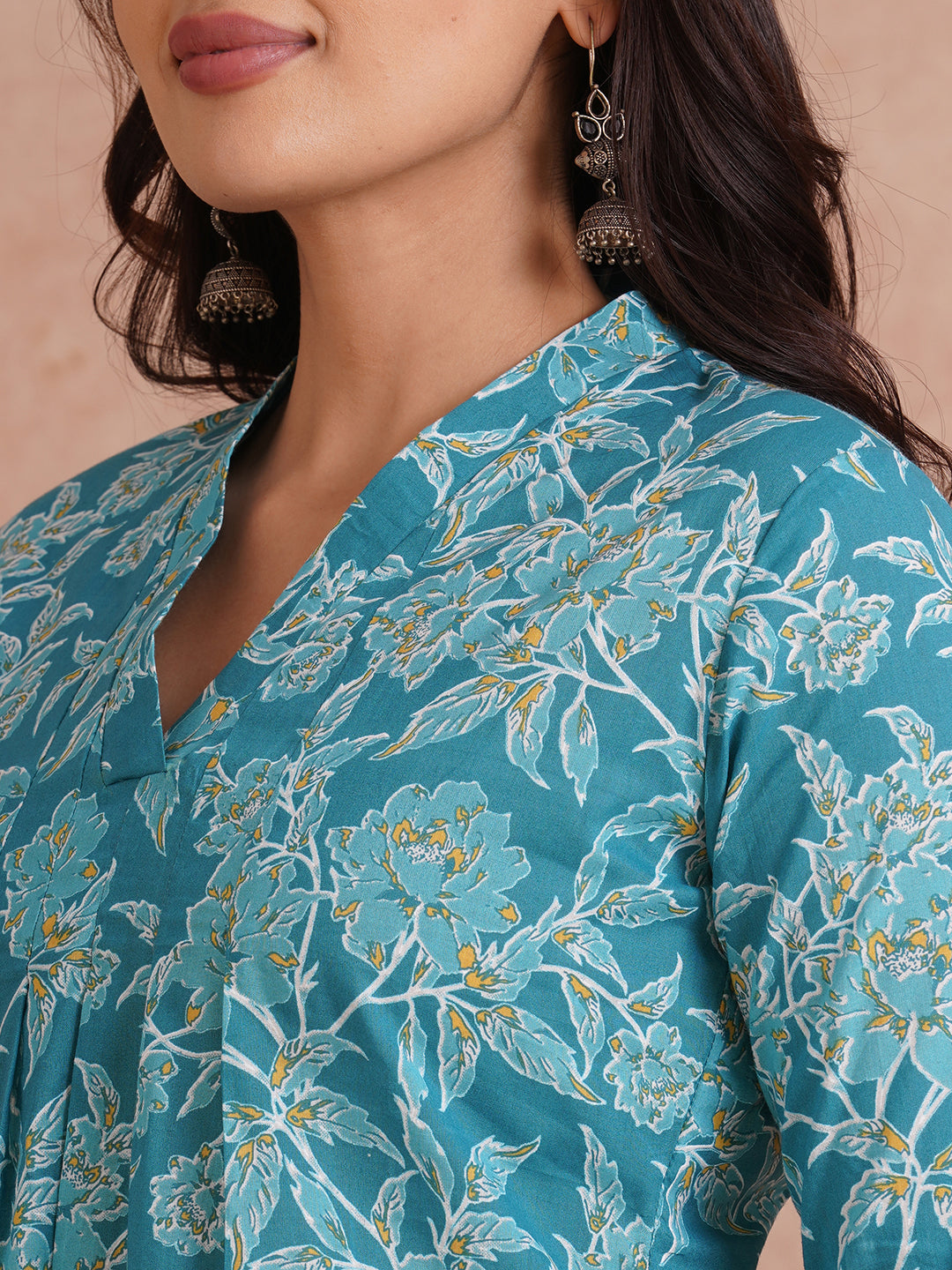 Printed top with knife pleat detailing and a V-neckline.