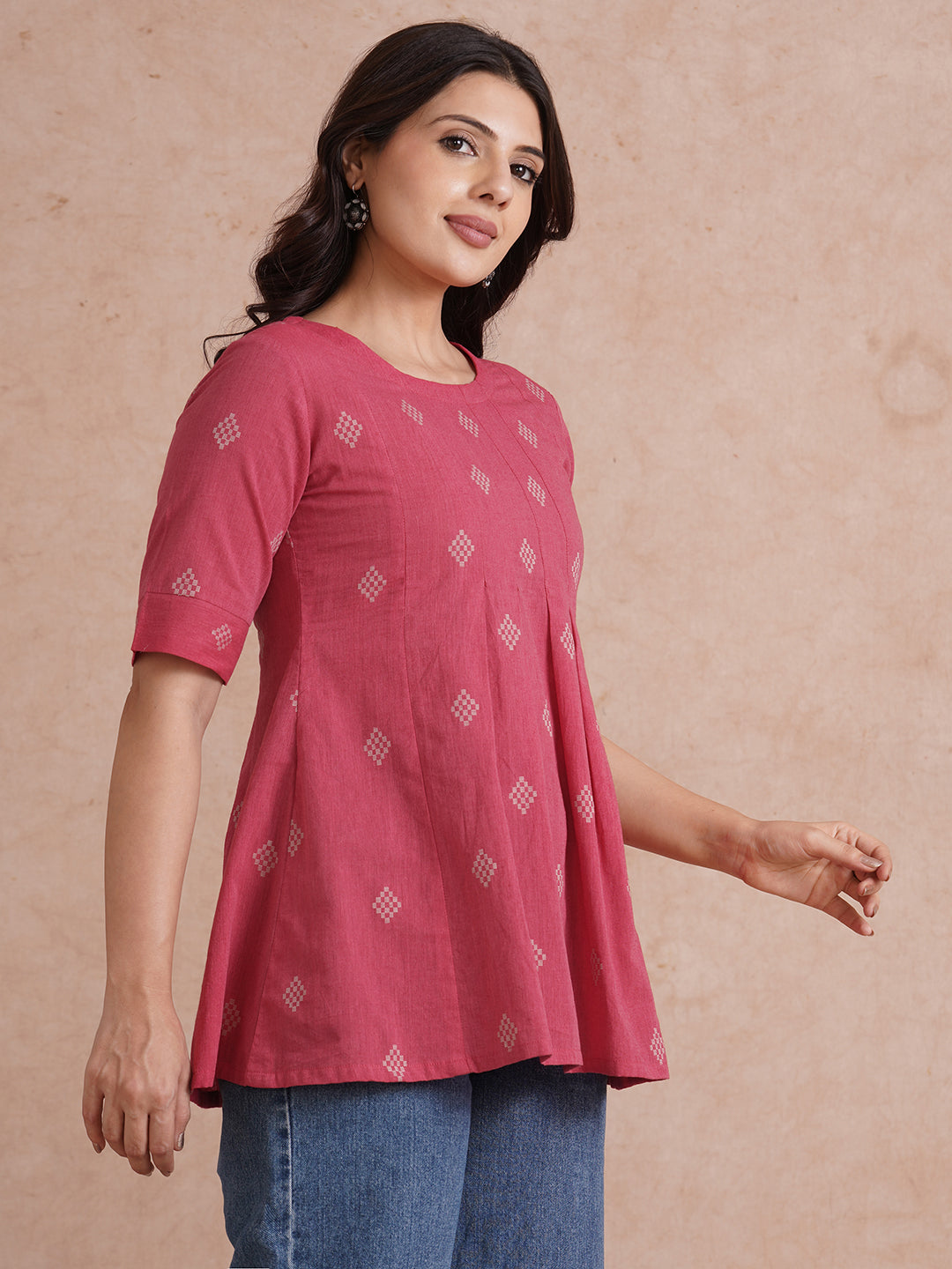 Pleated top with dobby fabric panels and elbow sleeves.