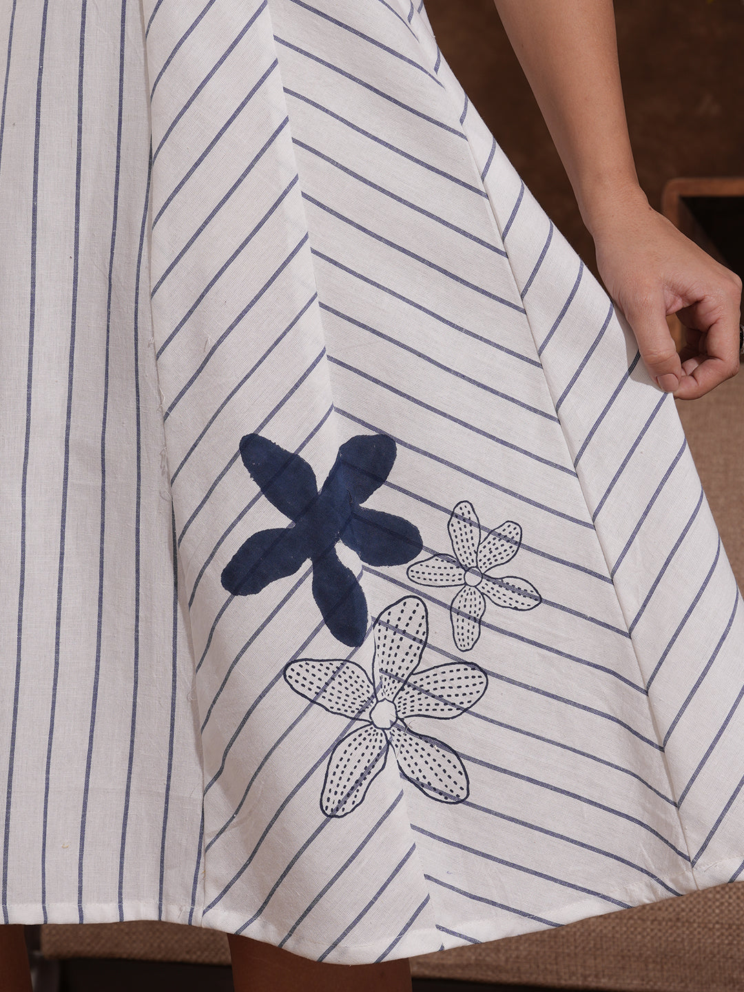 Pocketed striped sleeveless hand block printed dress with hand embroidery.