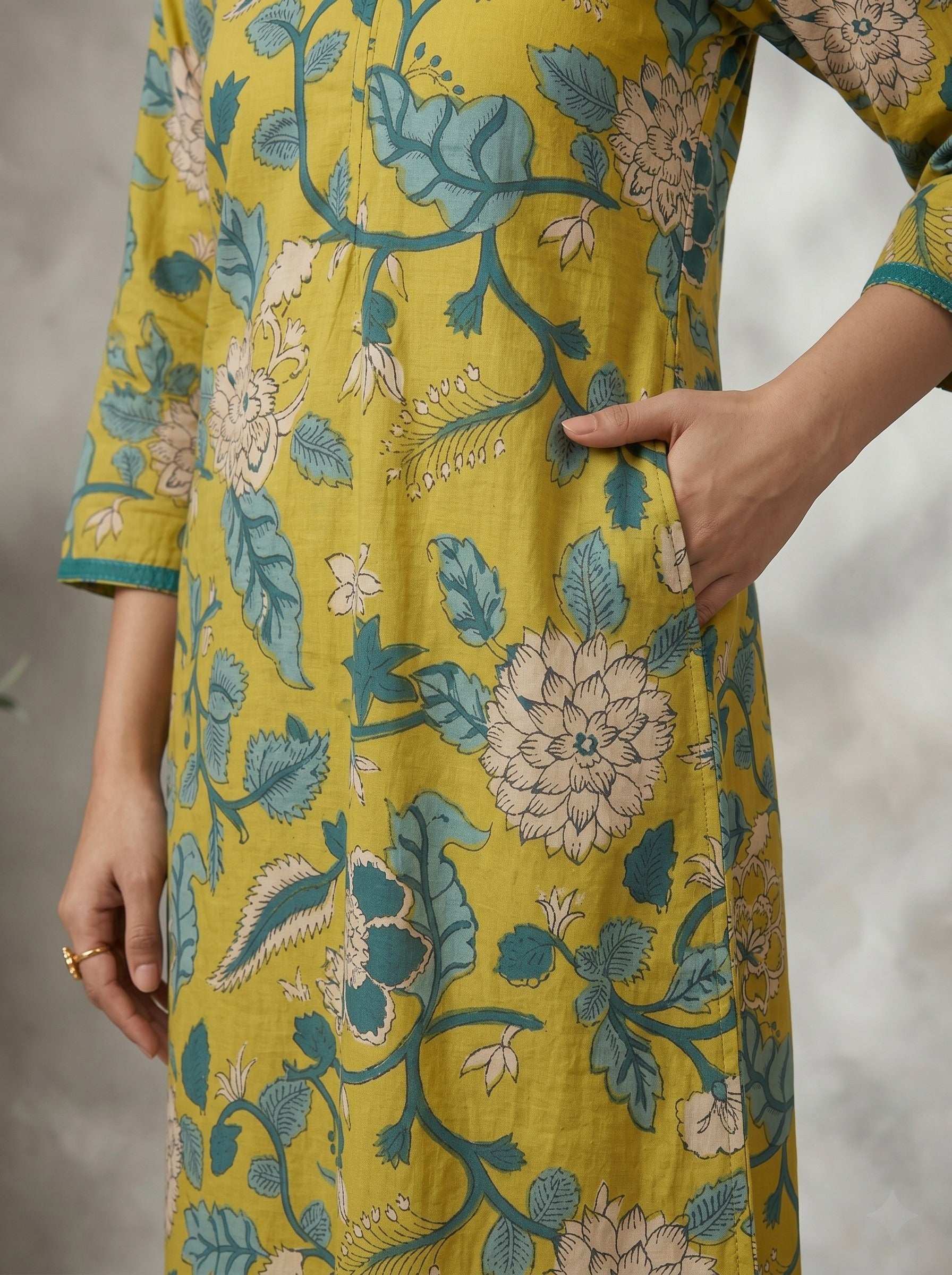 Mustard Floral Printed A-Line Cotton Kurta with Elegant V-Neck Mirror Detailing.