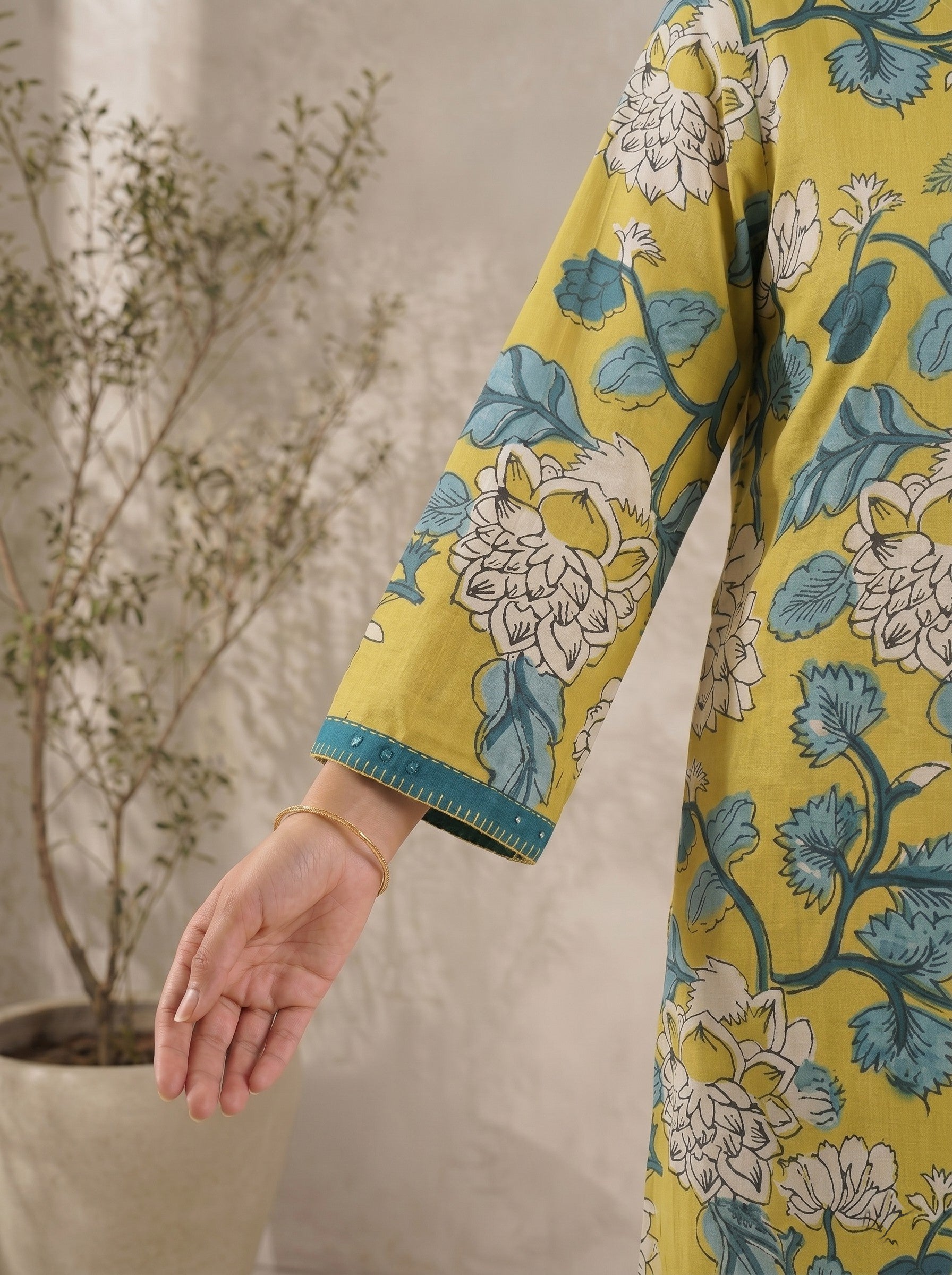 Mustard Floral Printed A-Line Cotton Kurta with Elegant V-Neck Mirror Detailing.