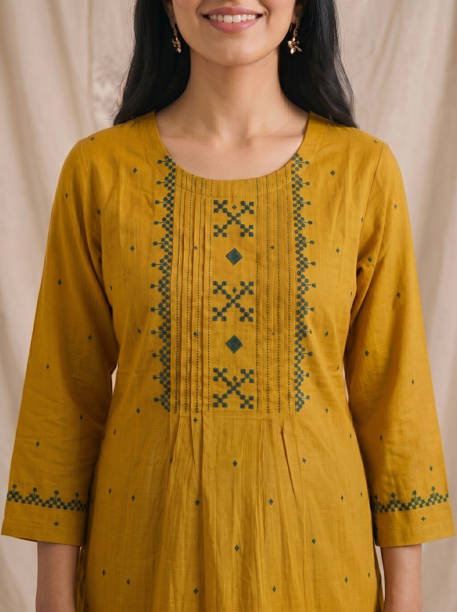 Straight fit cotton dobby kurta with tucks and block print on front and sleeves.