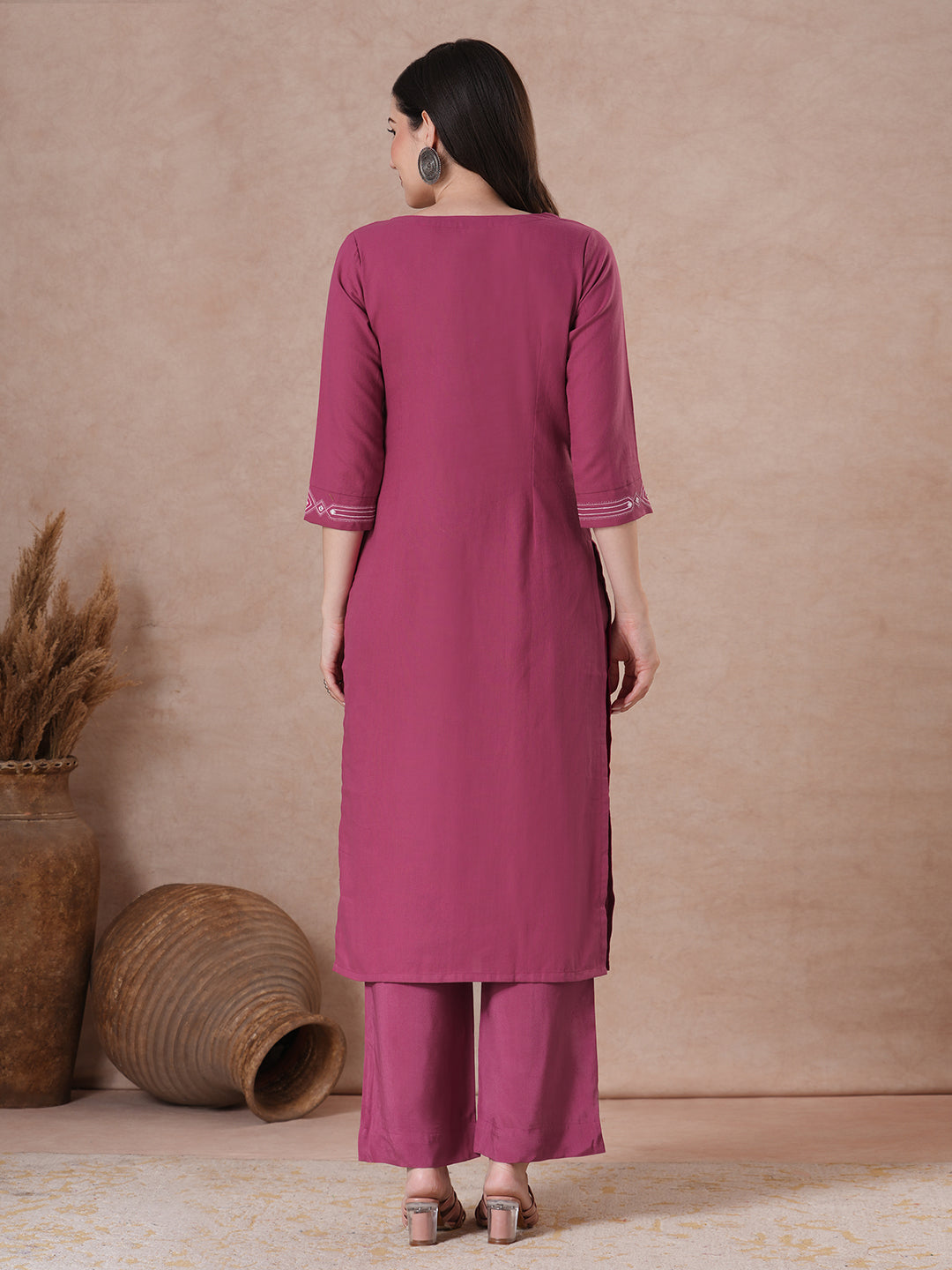 A straight fit kurta with minimal monochromatic embroidery on the neckline.