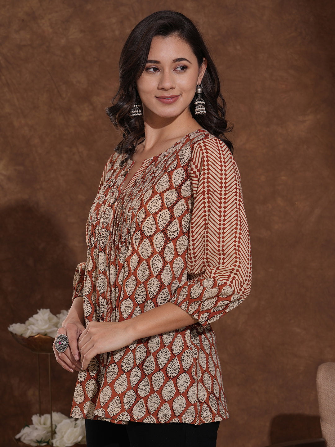 Hand block printed rust tunic with pleating and puff sleeves.