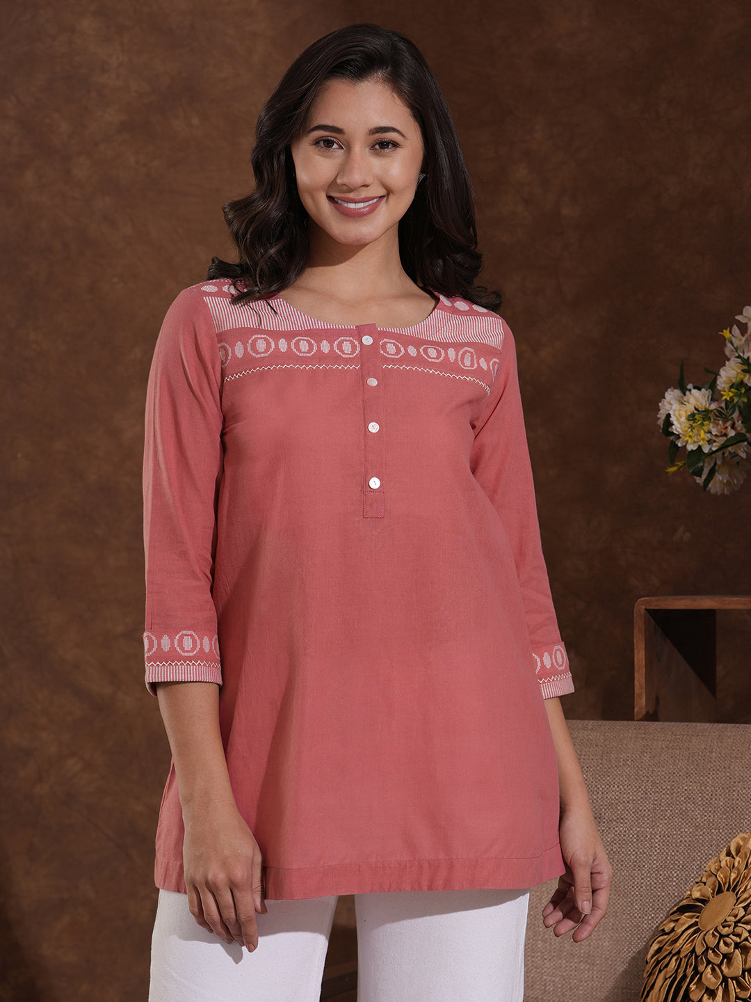 Woven cotton dobby tunic in light pink shade with hand embroidery.