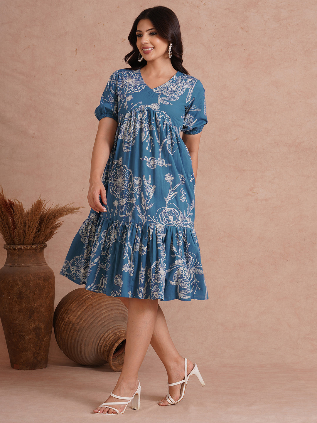 Tiered dress in printed cotton with an attached in seam pocket and puffed sleeves.