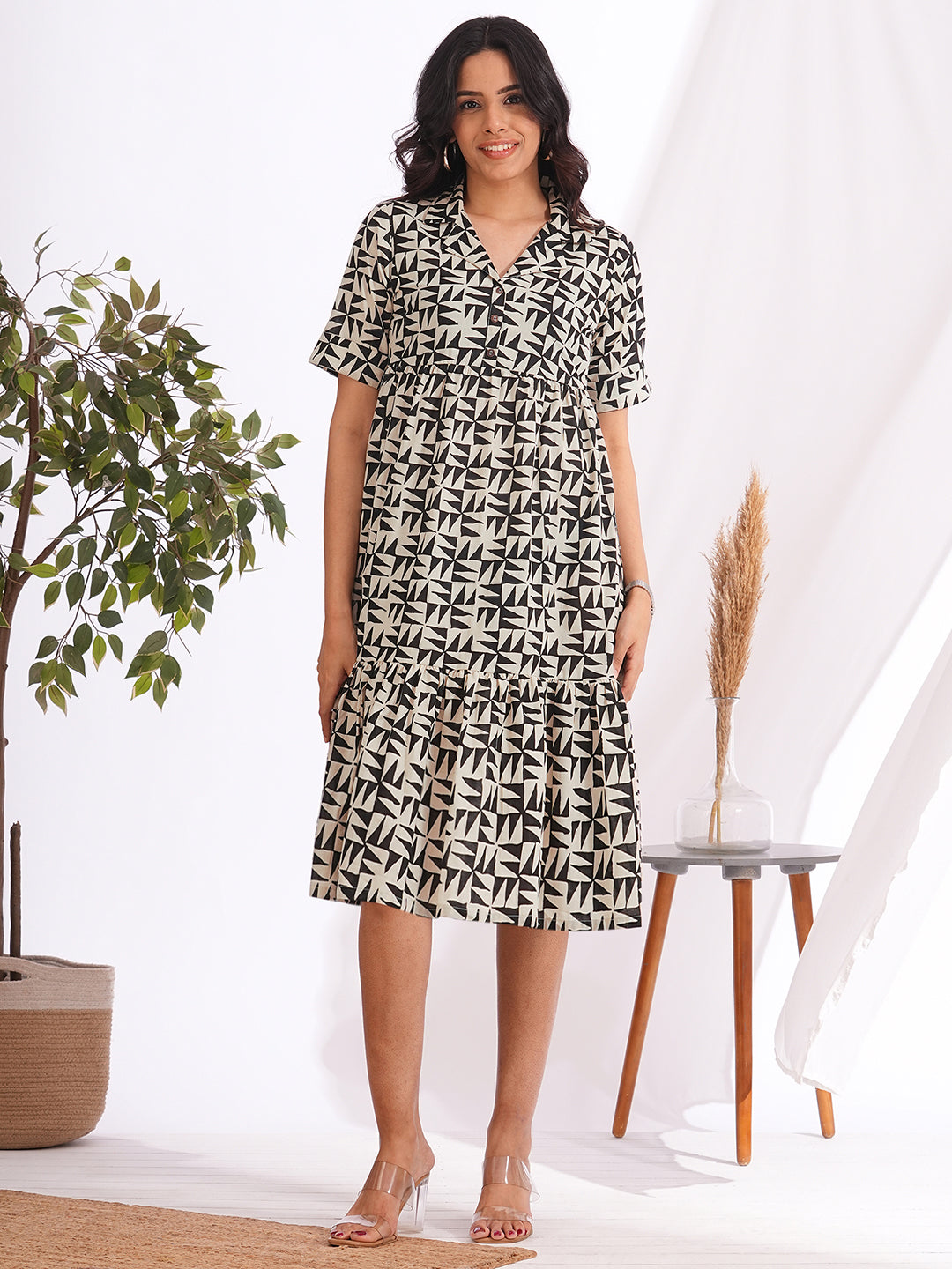 Pocketed cotton print tiered dress with a notched collar and an elbow length sleeve