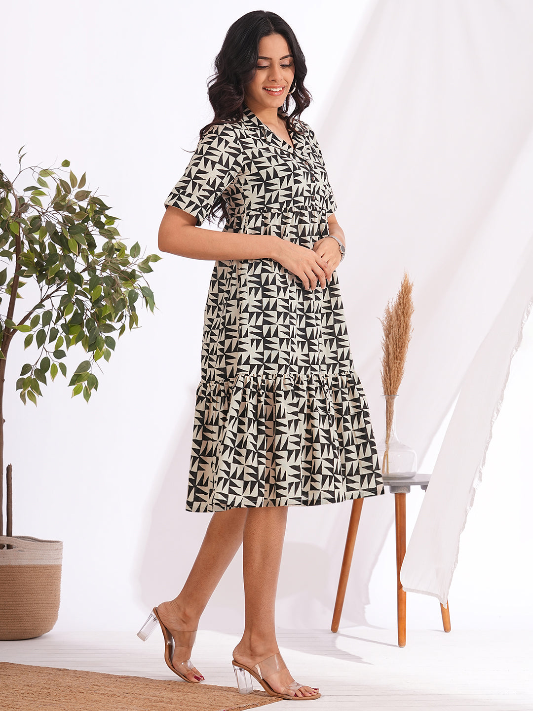 Pocketed cotton print tiered dress with a notched collar and an elbow length sleeve