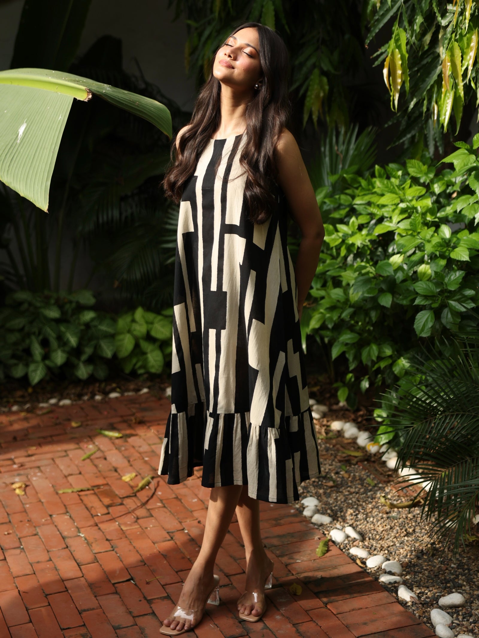 A-Line sleeveless cotton print dress with a tiered hemline and an attached in seam pocket