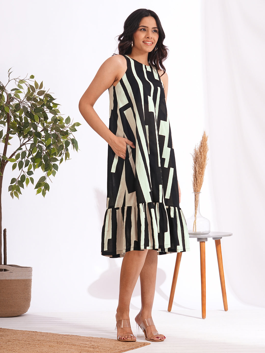 A-Line sleeveless cotton print dress with a tiered hemline and an attached in seam pocket