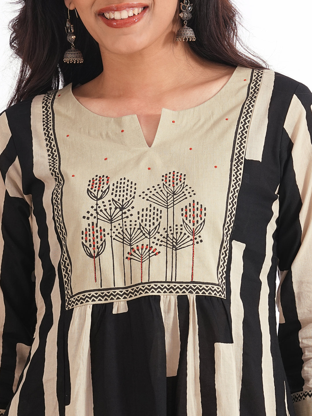 A-line printed suit set paired with a solid bottom and block printed mal dupatta.