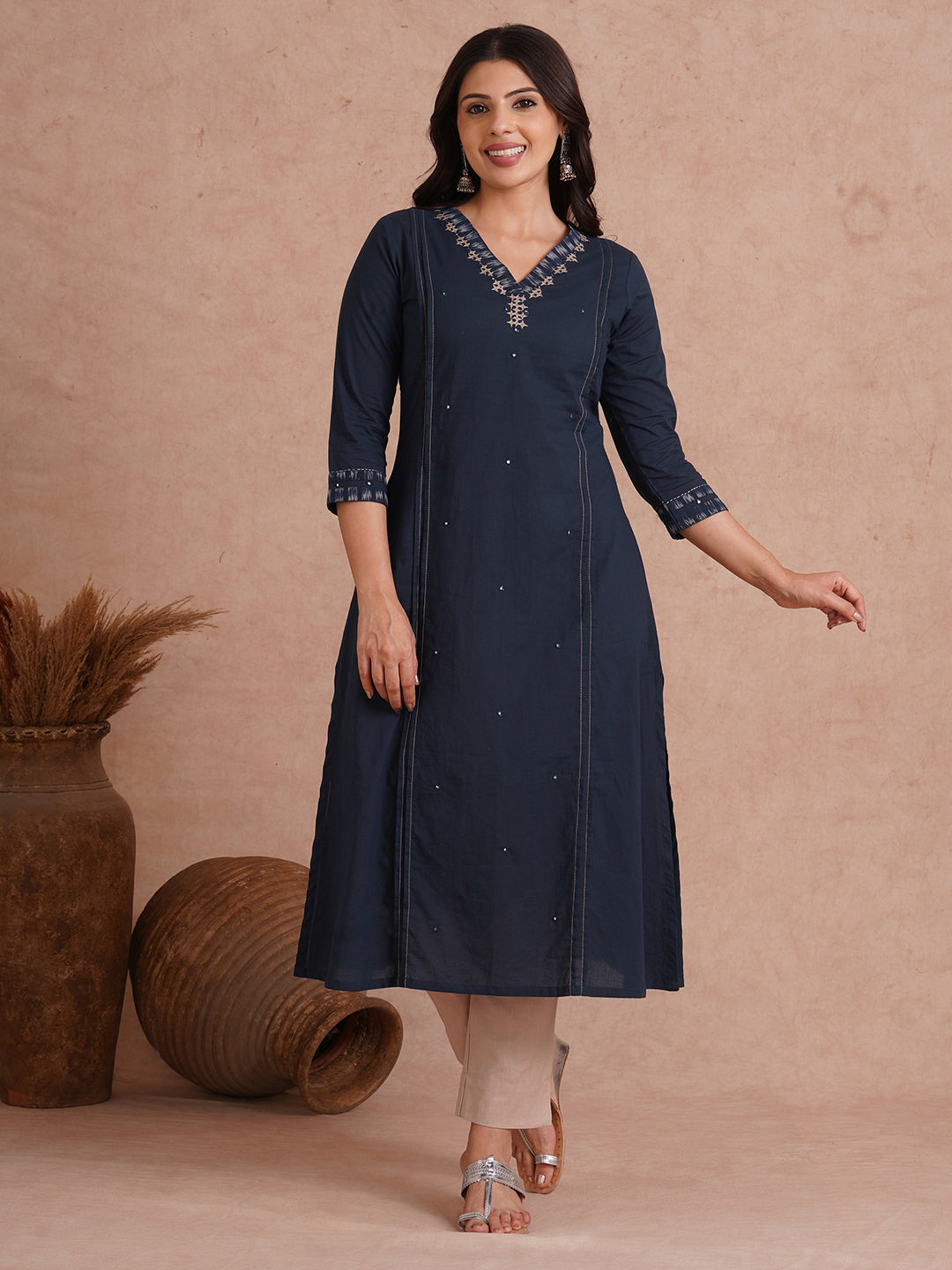 Pocketed A-Line cotton kurta with traditional 'chatakla' embroidery and mirror work.