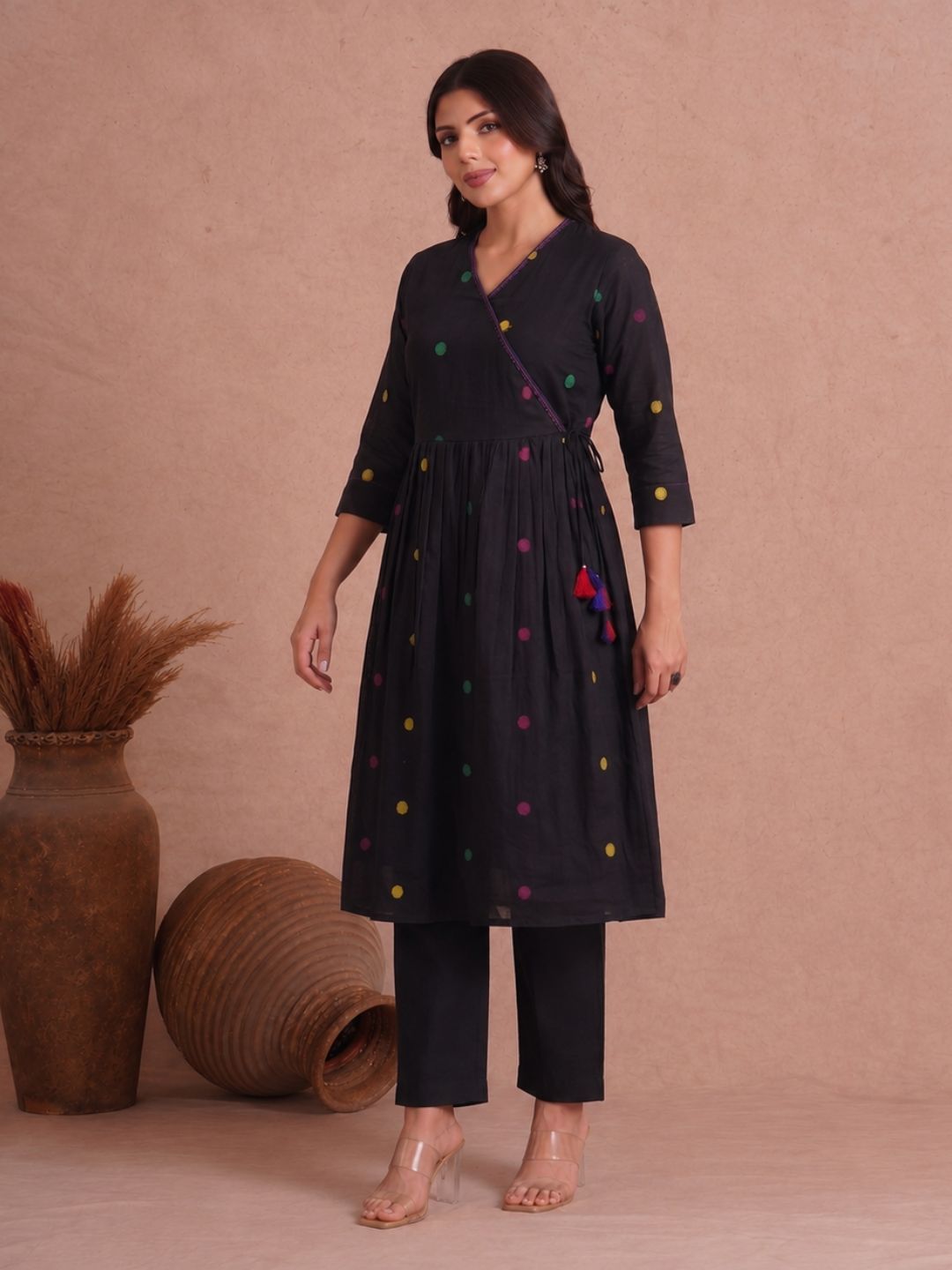 Pocketed and A-line Fit and Flare Angrakha style Dobby kurta with handwork, tassels and gathering.