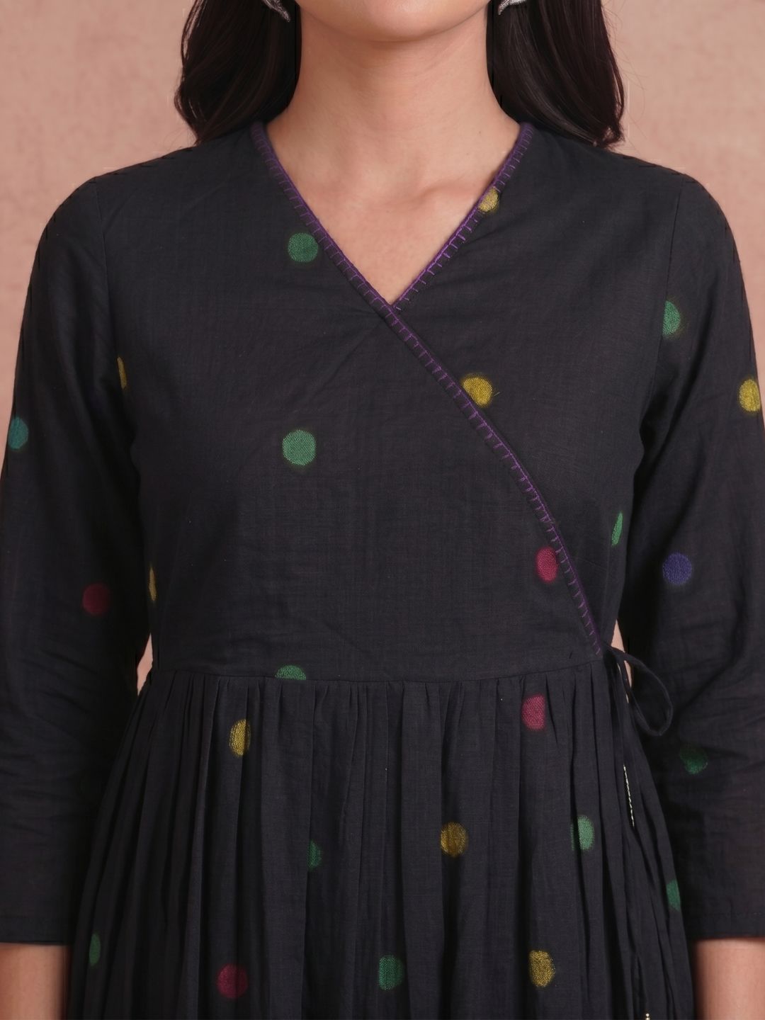 Pocketed and A-line Fit and Flare Angrakha style Dobby kurta with handwork, tassels and gathering.