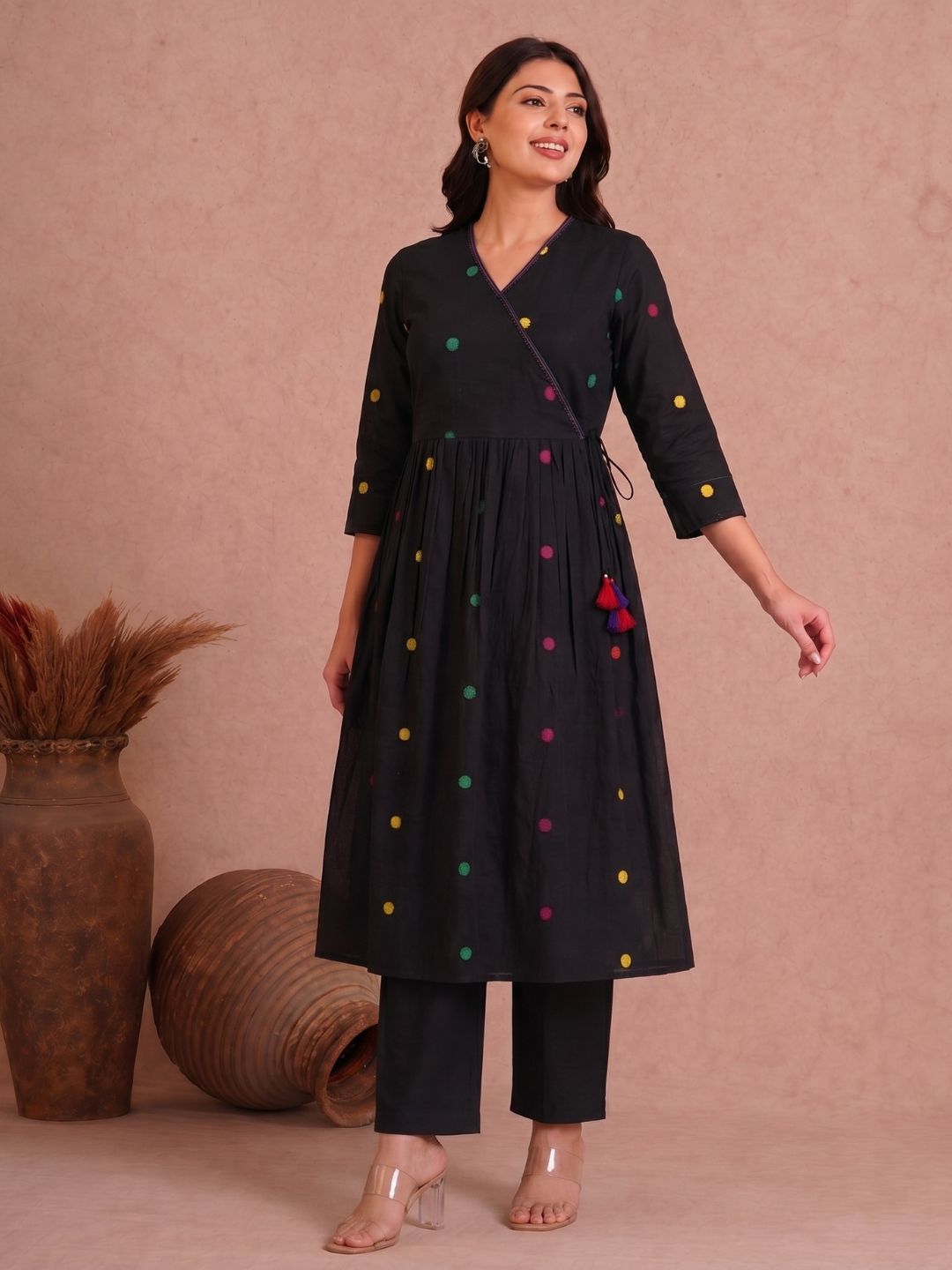 Pocketed and A-line Fit and Flare Angrakha style Dobby kurta with handwork, tassels and gathering.